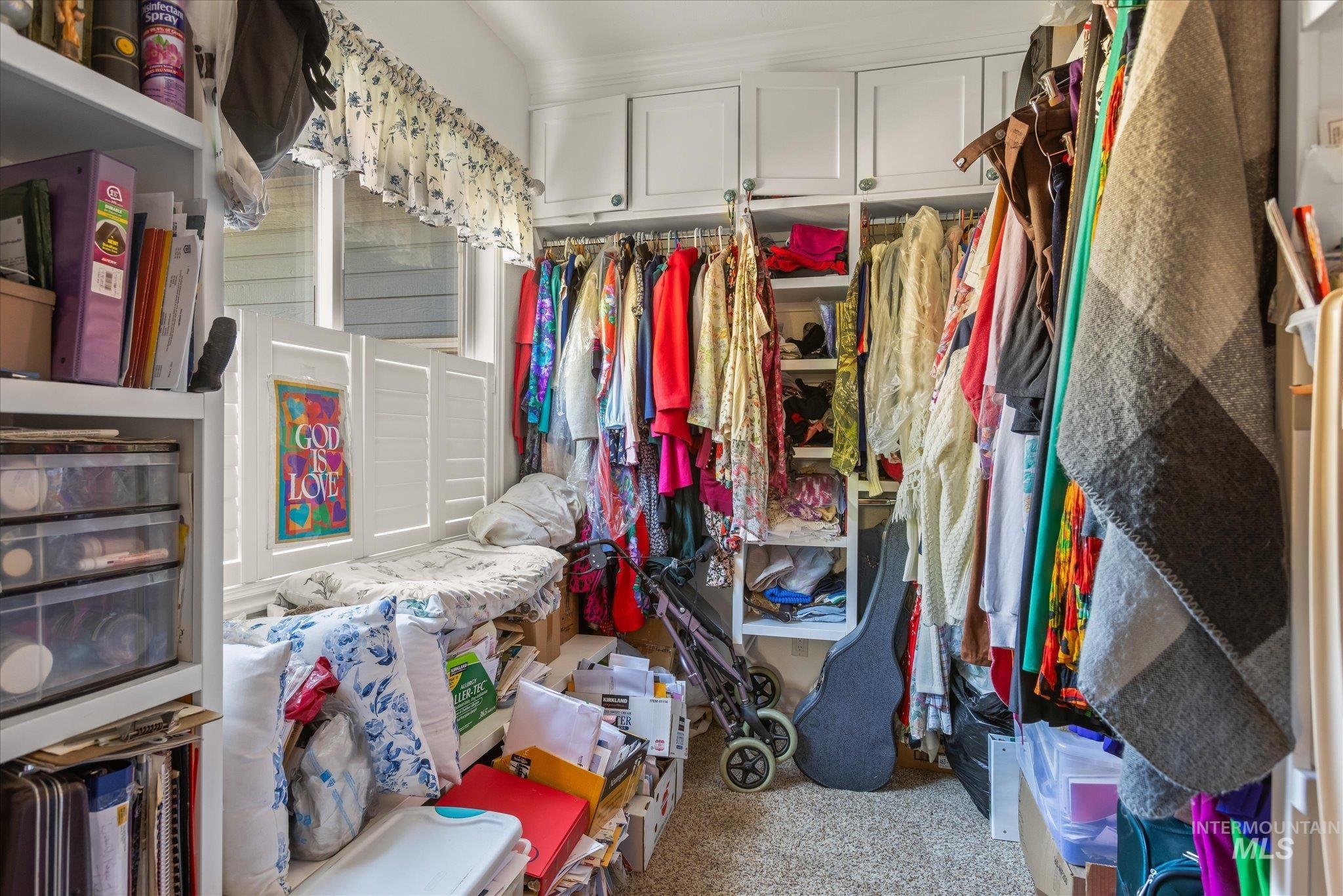 Walk in closet with light carpet
