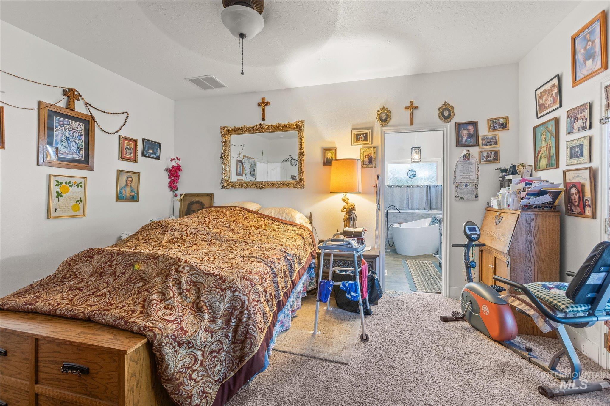 Carpeted bedroom featuring a ceiling fan