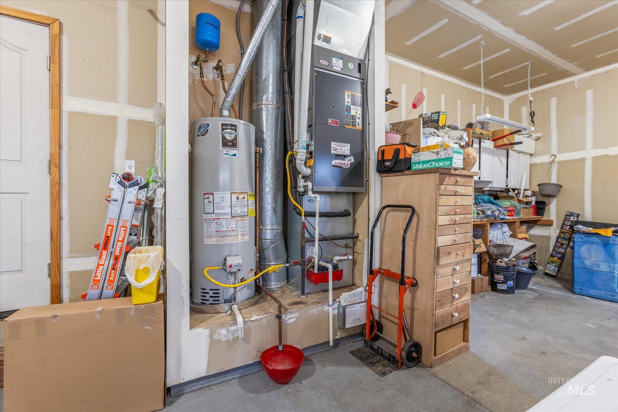 Utility room with water heater and heating unit