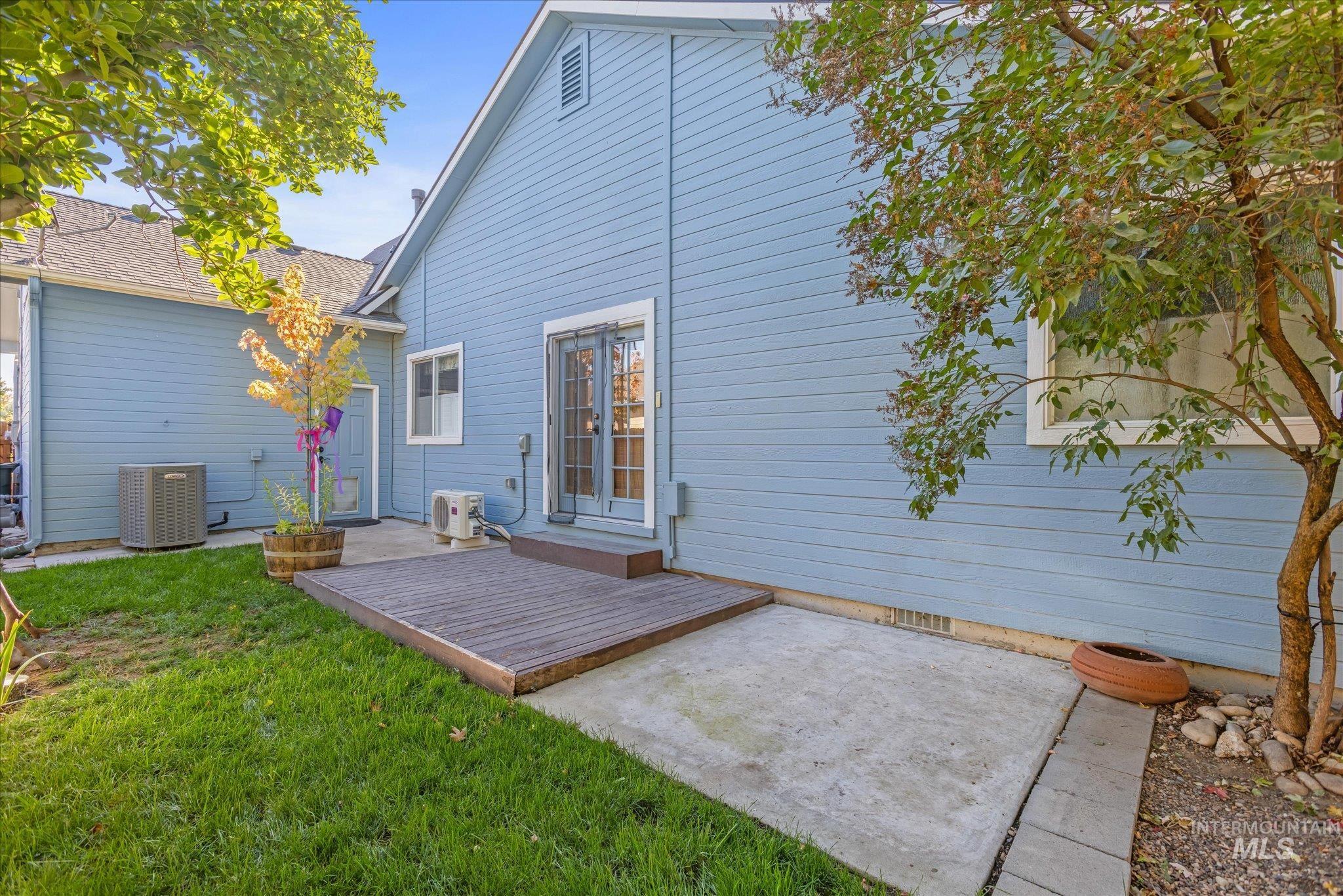 Rear view of property with a patio area and a lawn