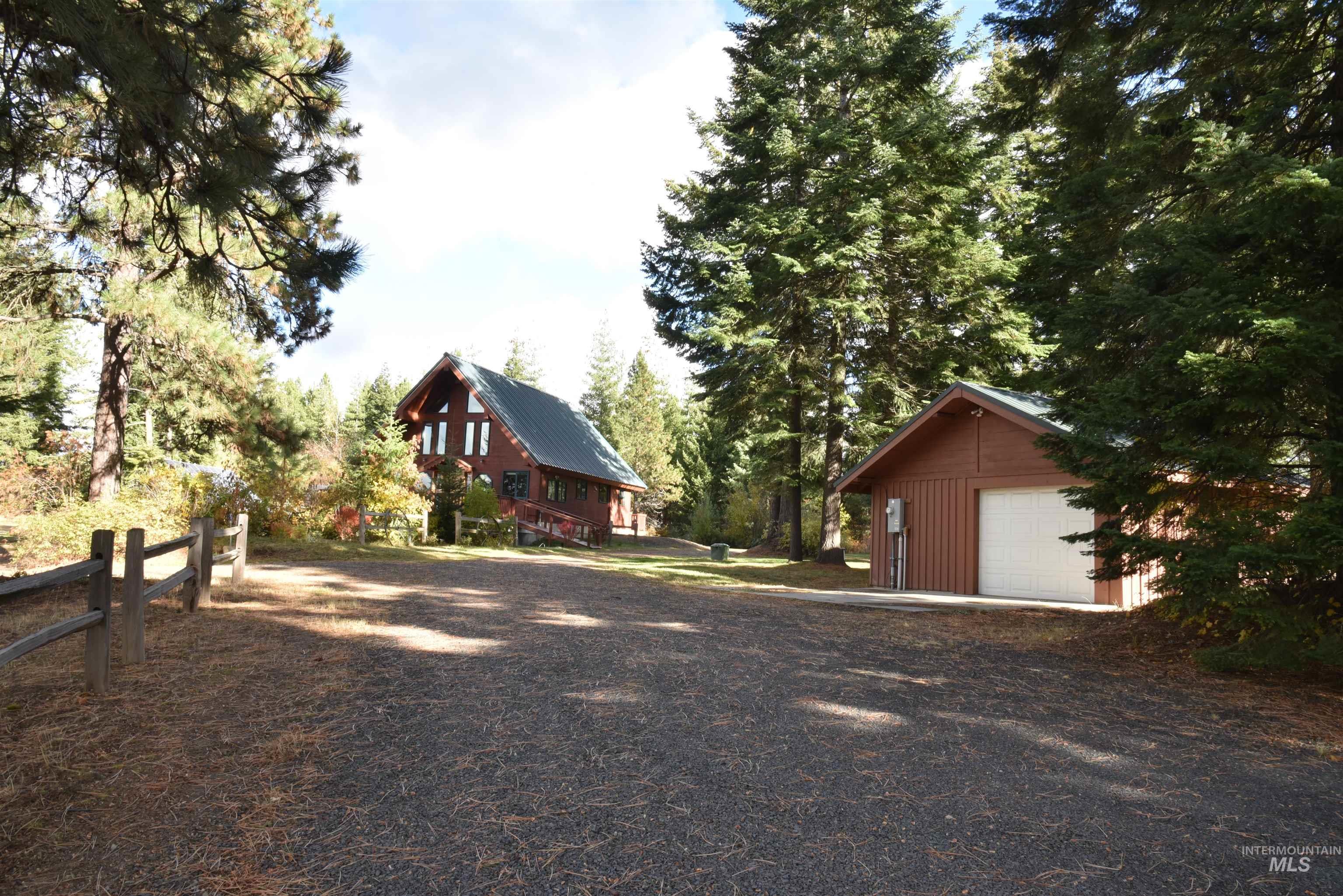 View of side of home featuring an outbuilding and a garage