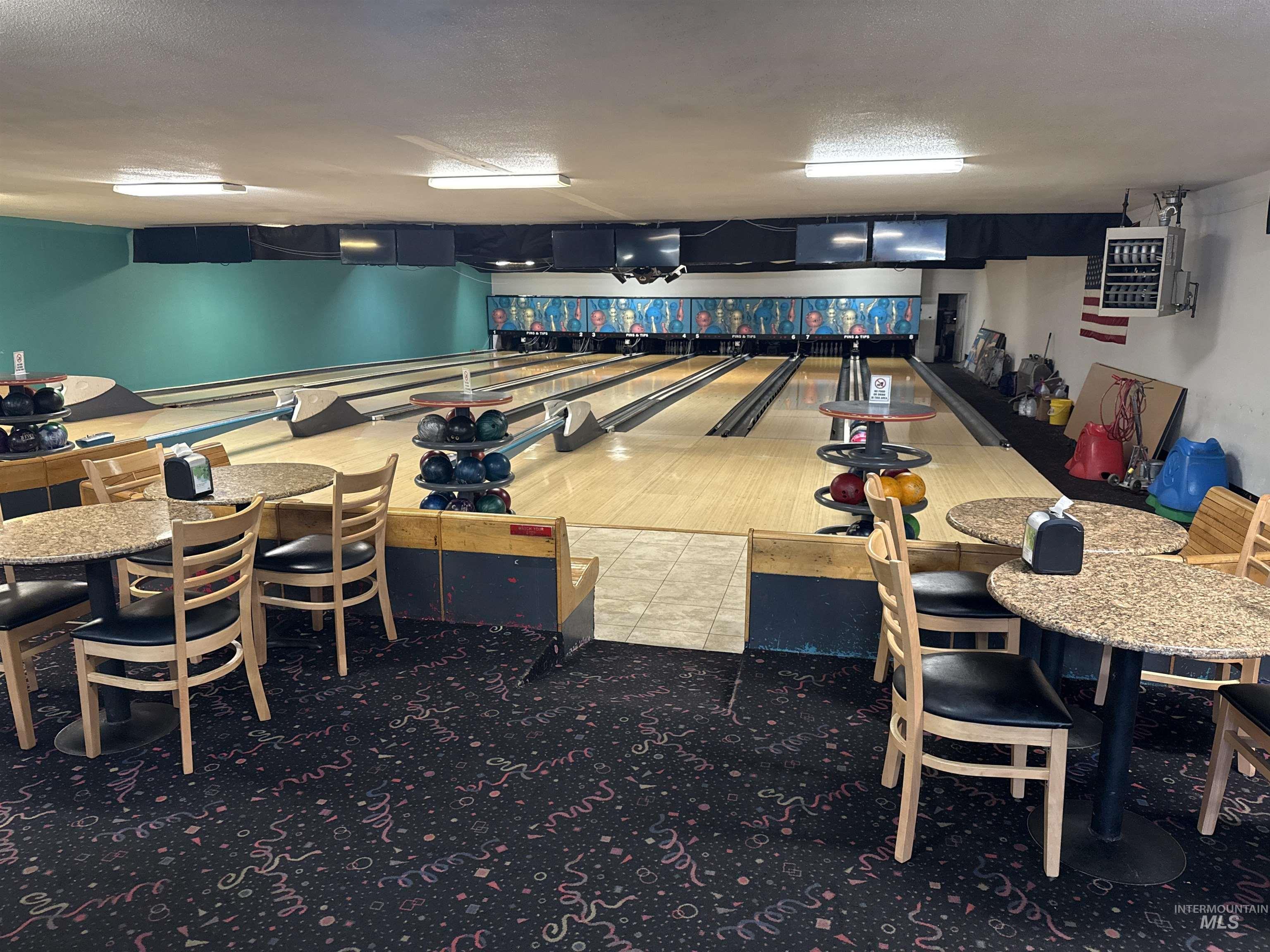 Dining space featuring a bowling alley and a textured ceiling