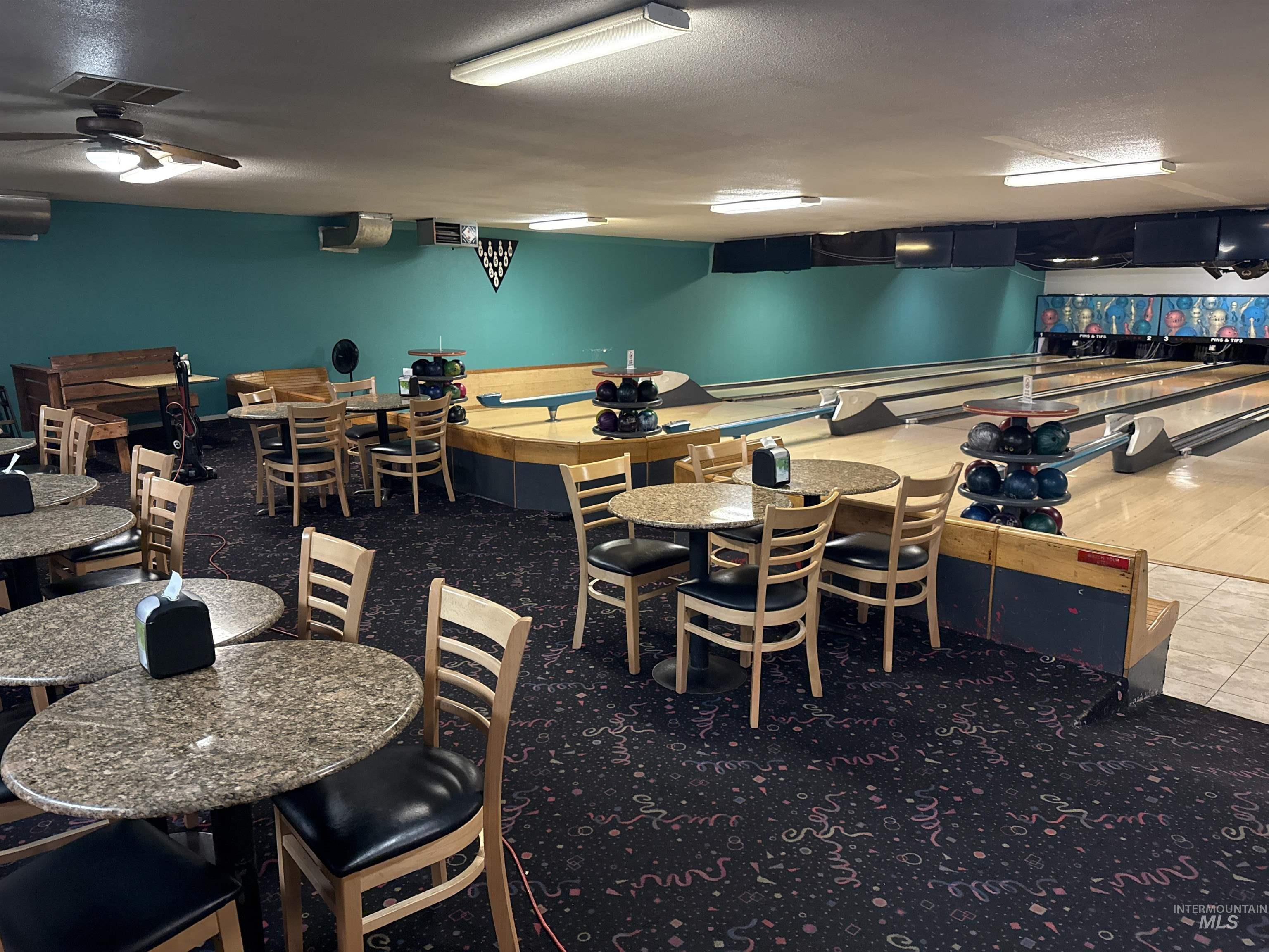 Dining area with a textured ceiling and an AC wall unit