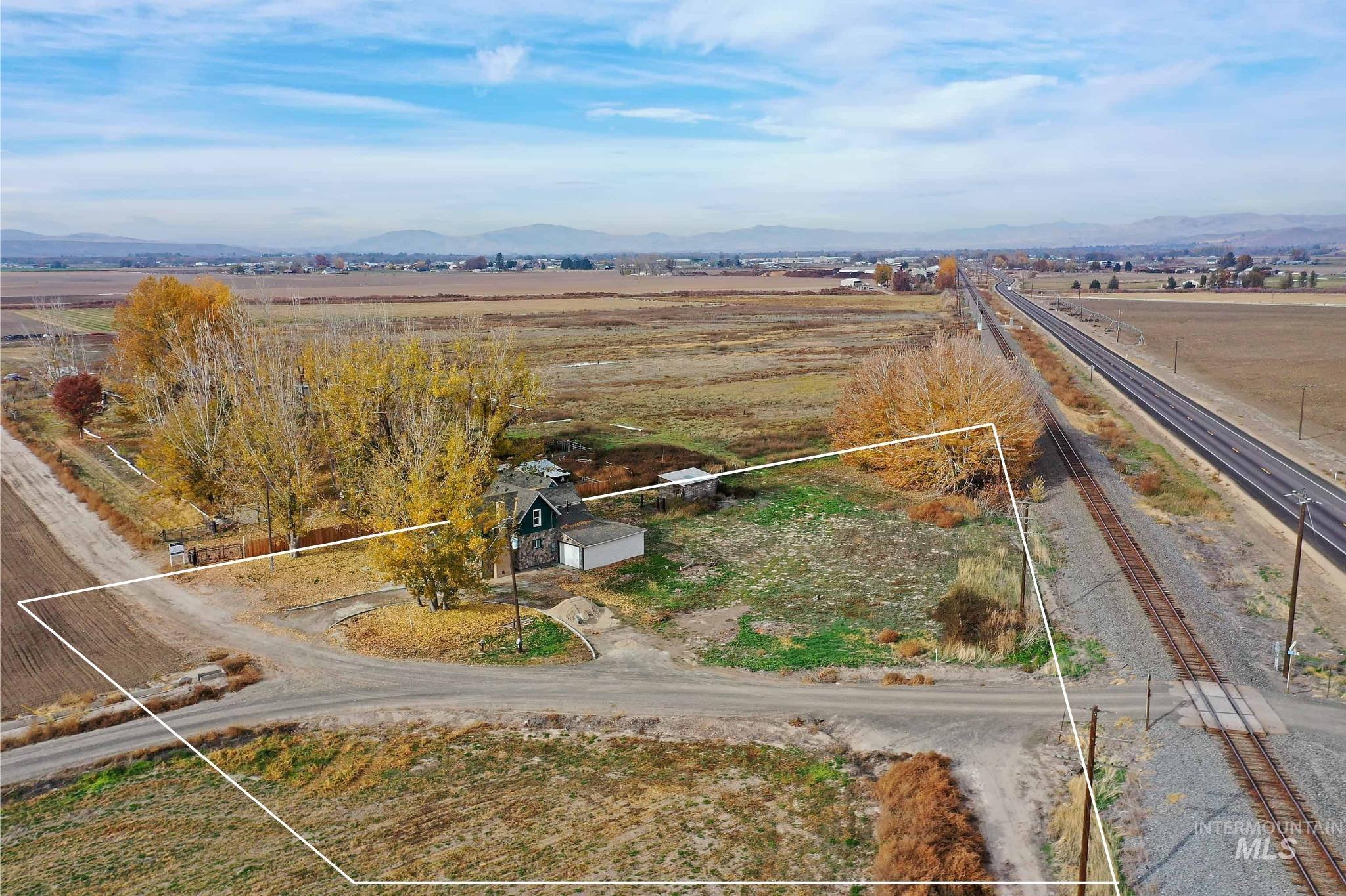 View of rural area with property parcel outlined and a mountain backdrop