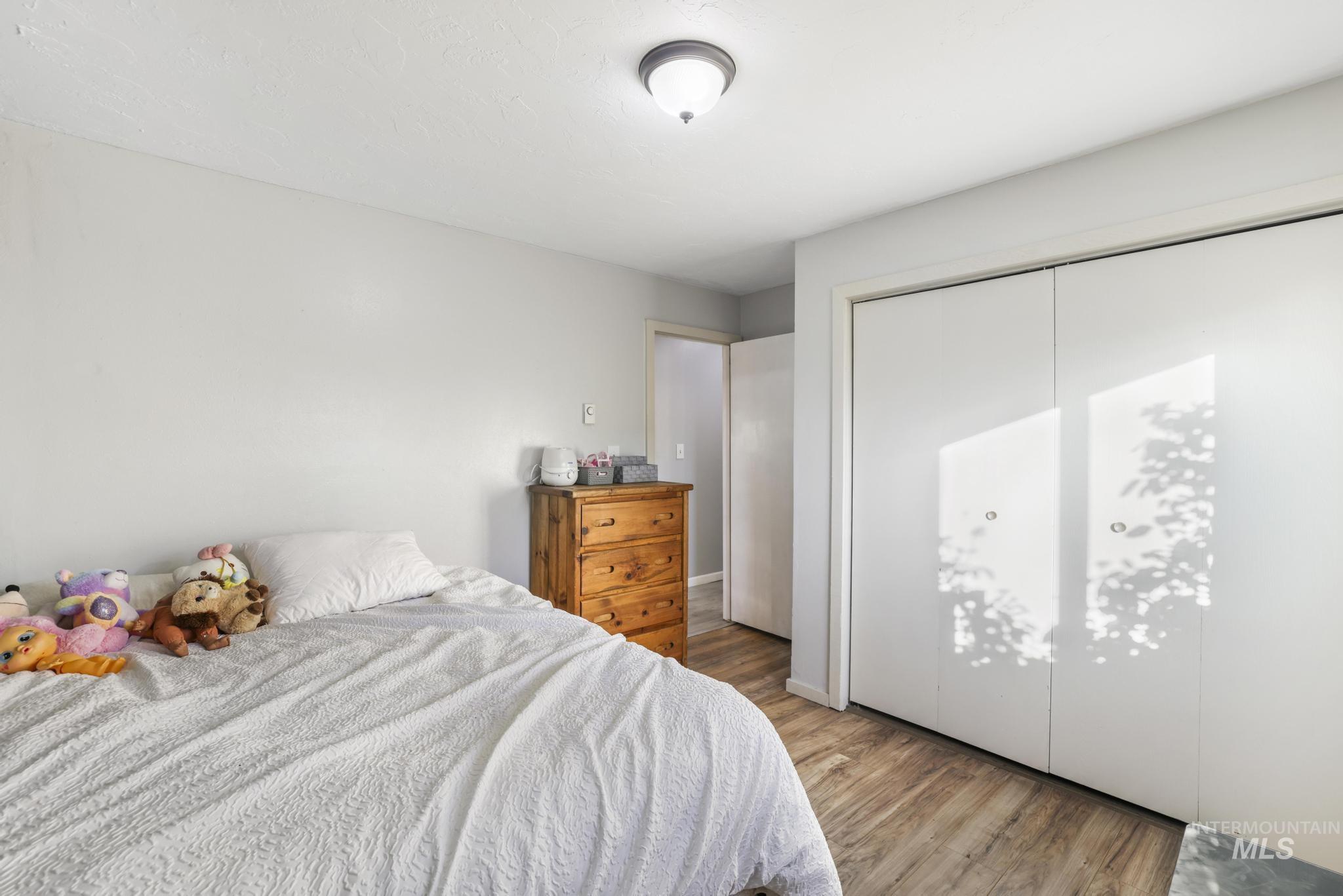 Bedroom featuring light wood-style flooring and a closet