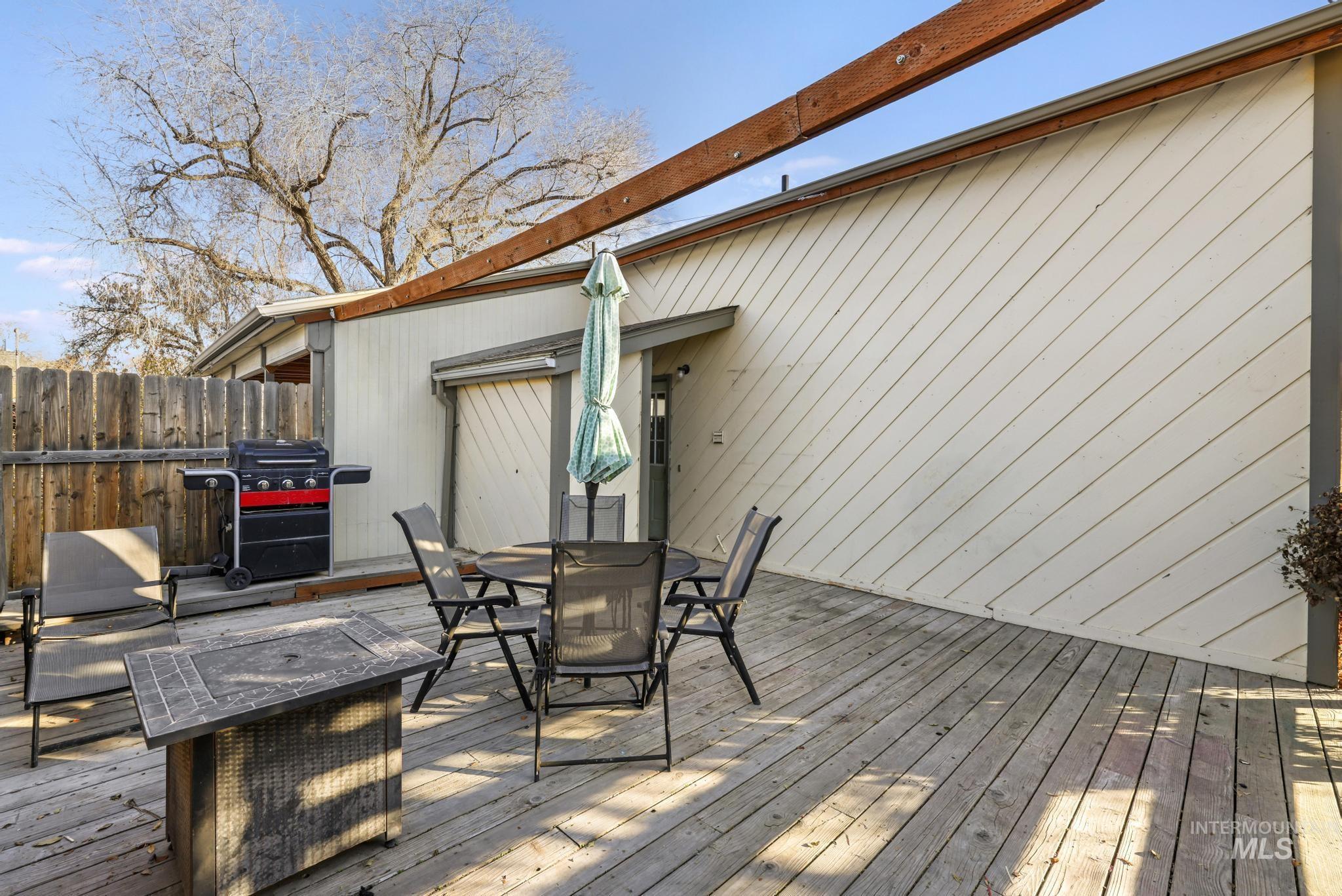 Deck with outdoor dining area and a grill