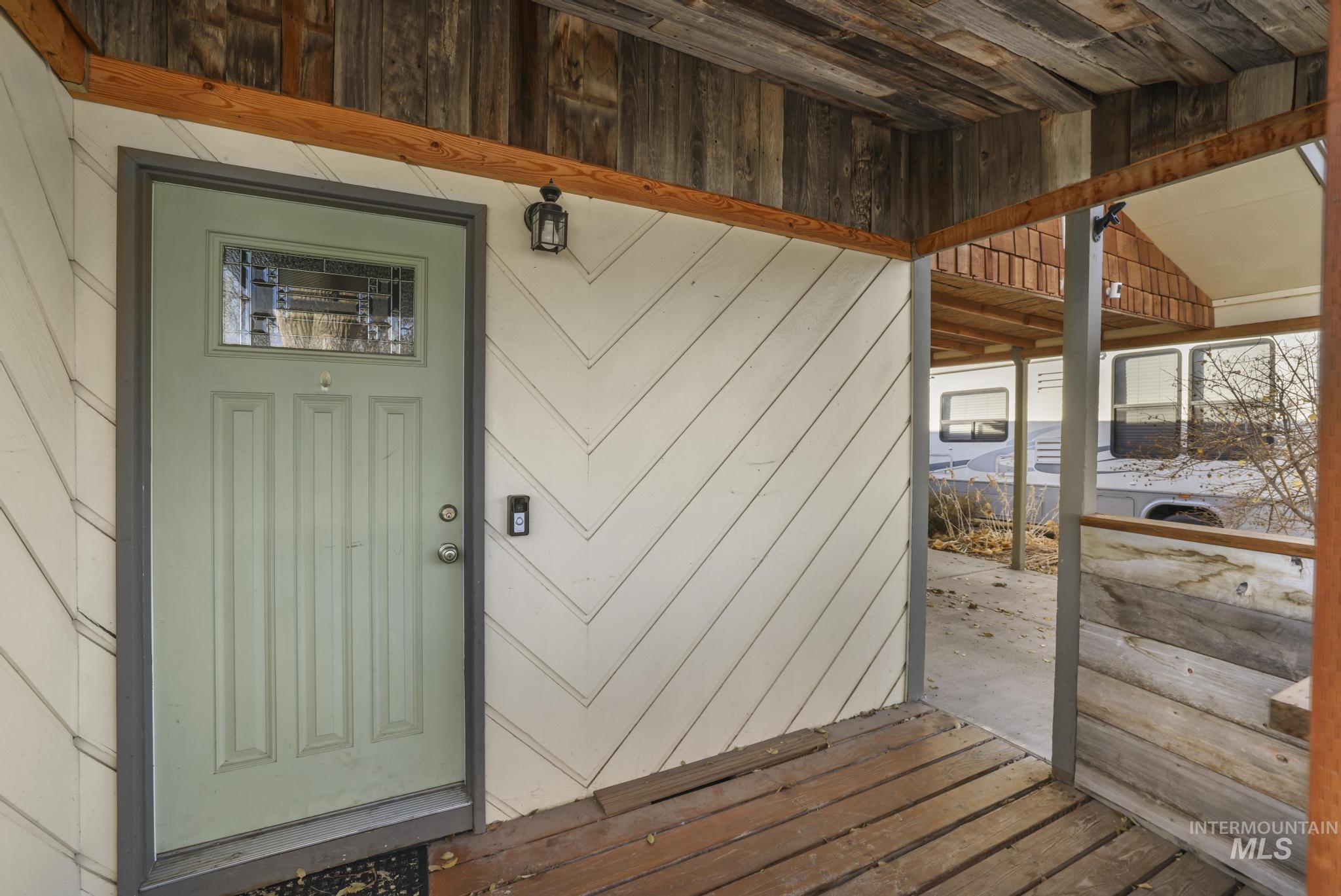 View of exterior entry with a patio area