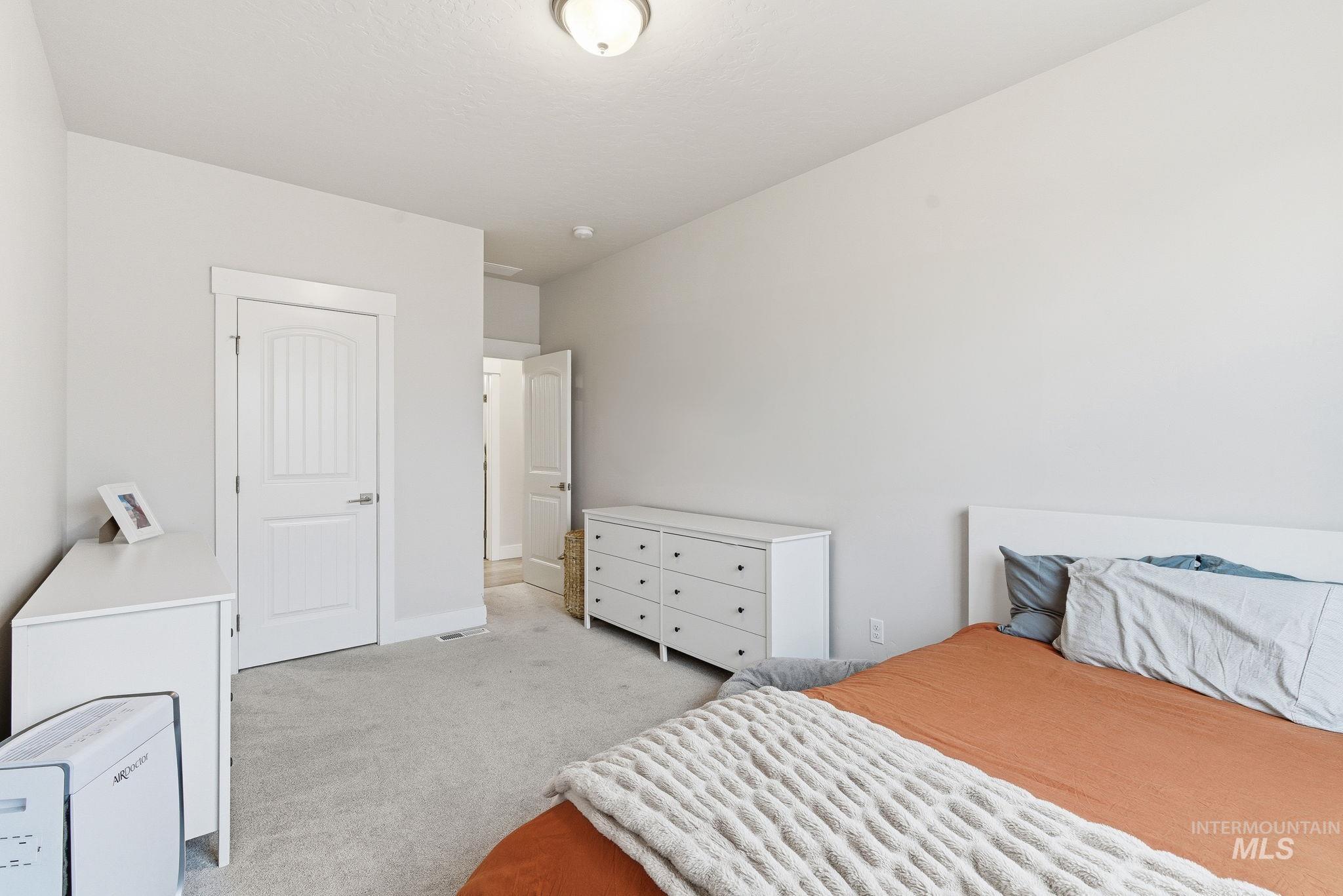 Bedroom with light colored carpet