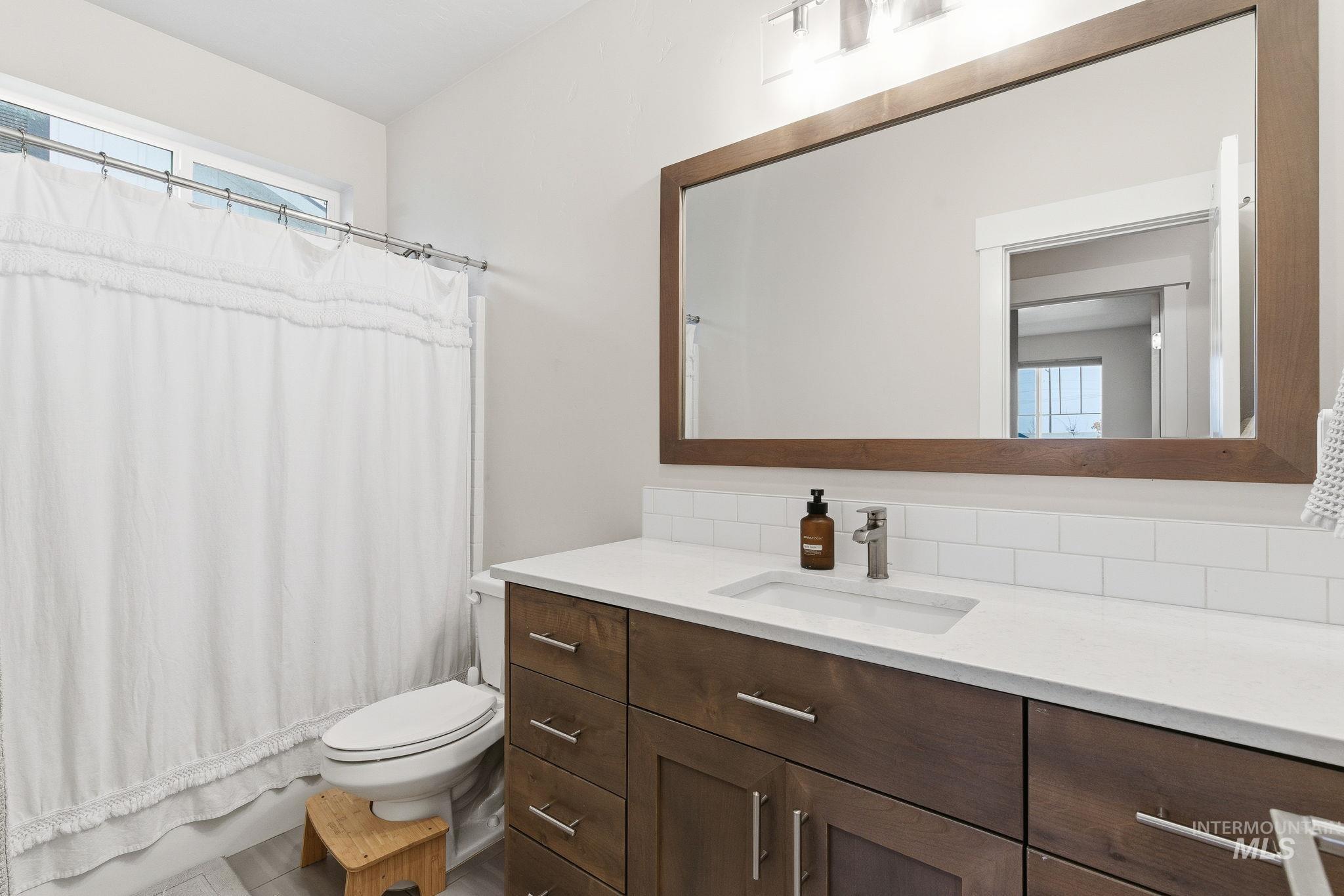 Full bathroom featuring plenty of natural light and vanity