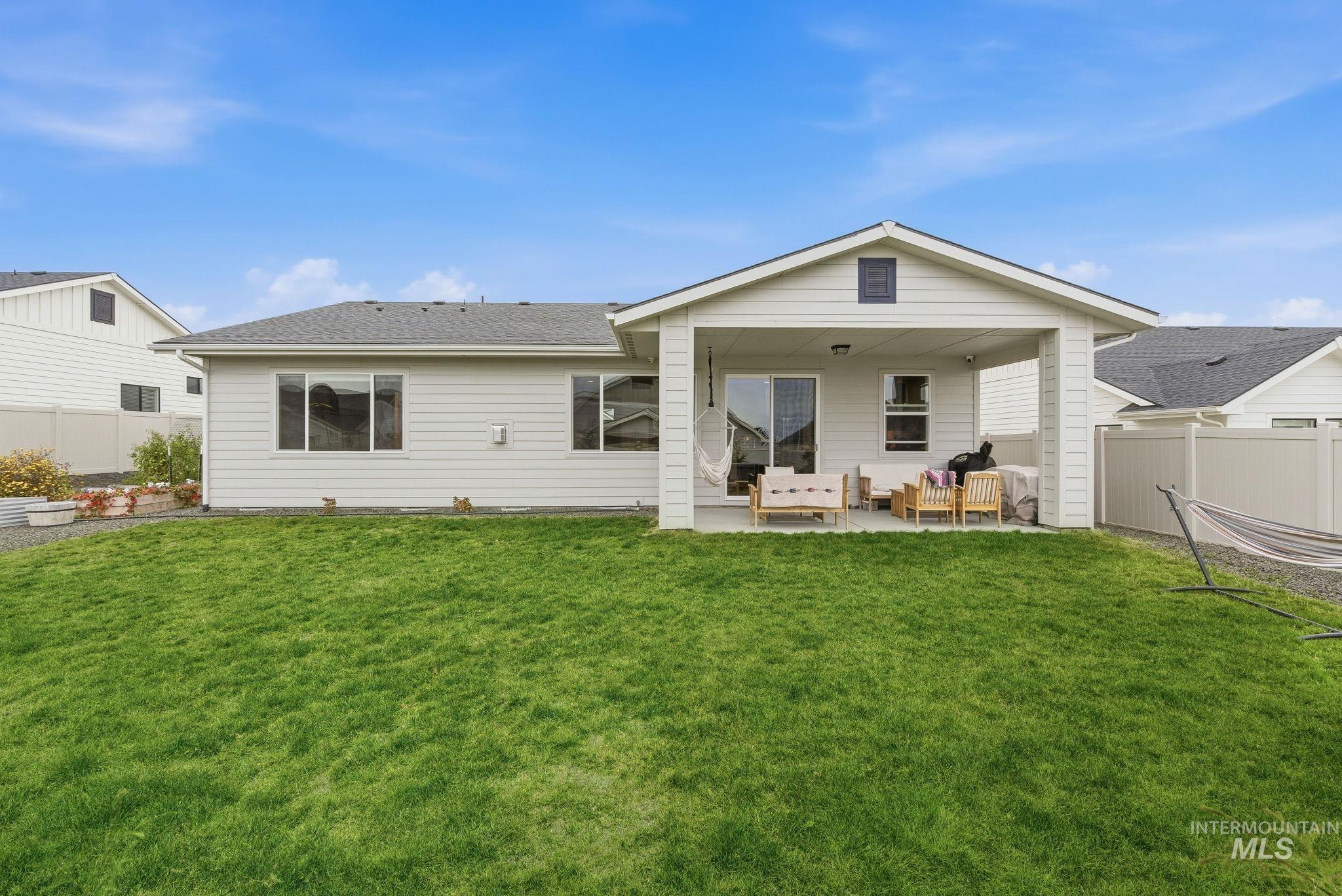 Rear view of house featuring a patio area and an outdoor living space