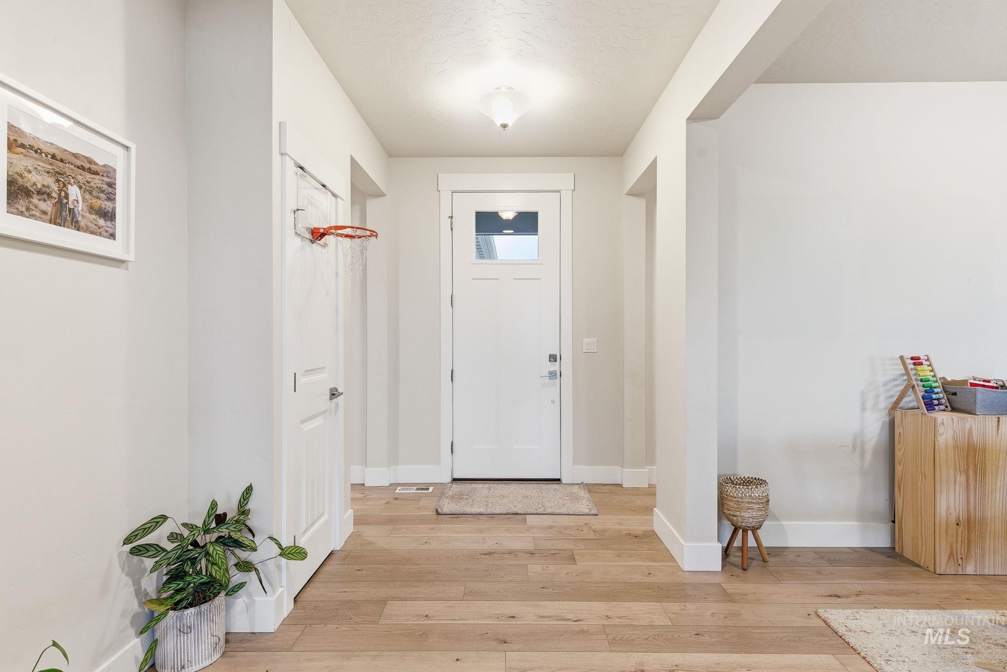 Foyer entrance with baseboards and light wood finished floors