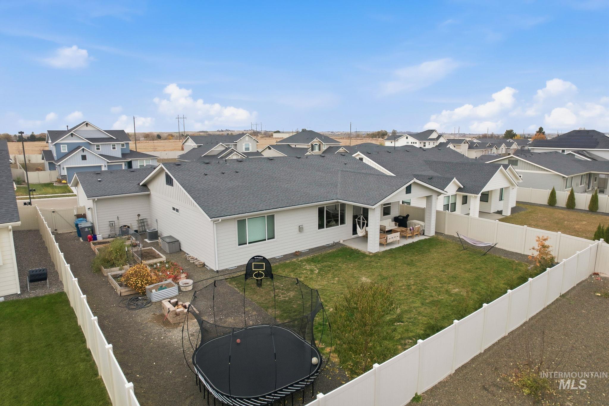 Rear view of house with a patio, a fenced backyard, and a residential view