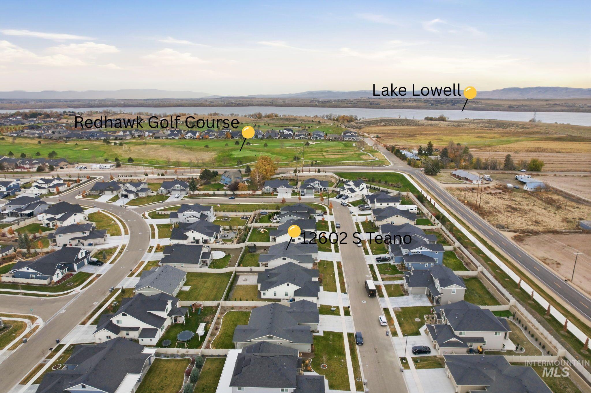 View of property location featuring nearby suburban area and a water and mountain view