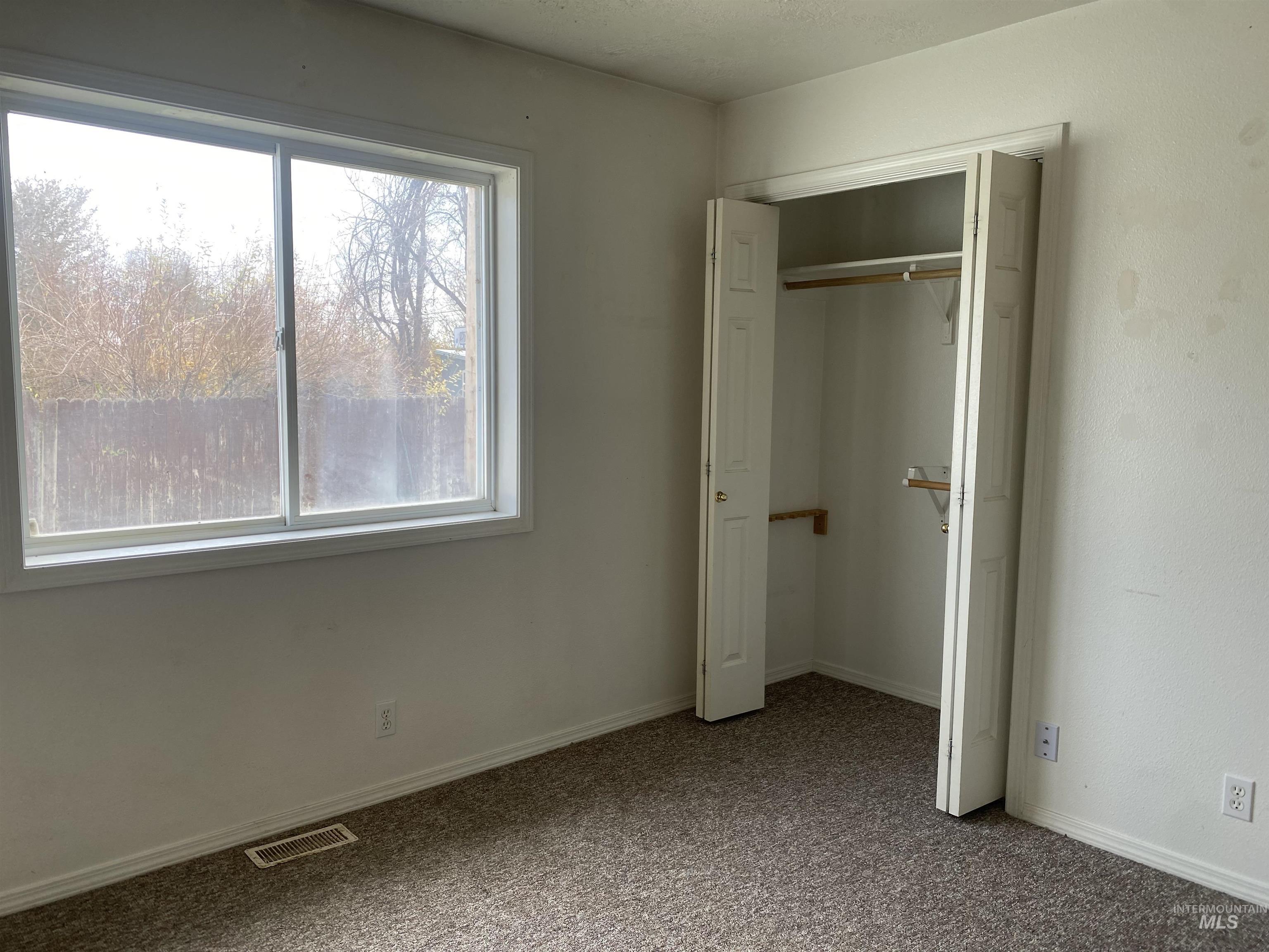 Unfurnished bedroom with carpet floors and a closet