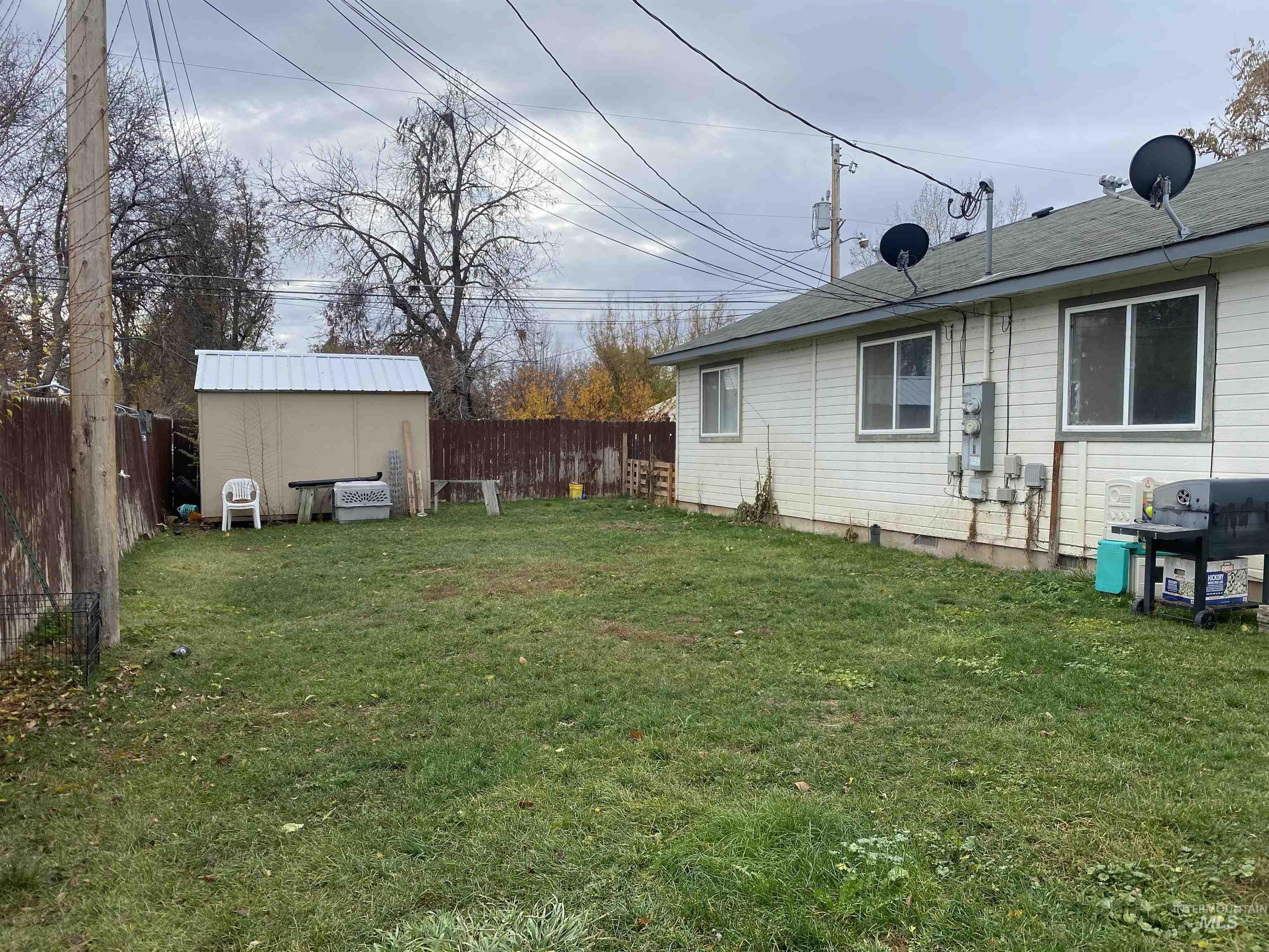 Fenced backyard with a storage unit