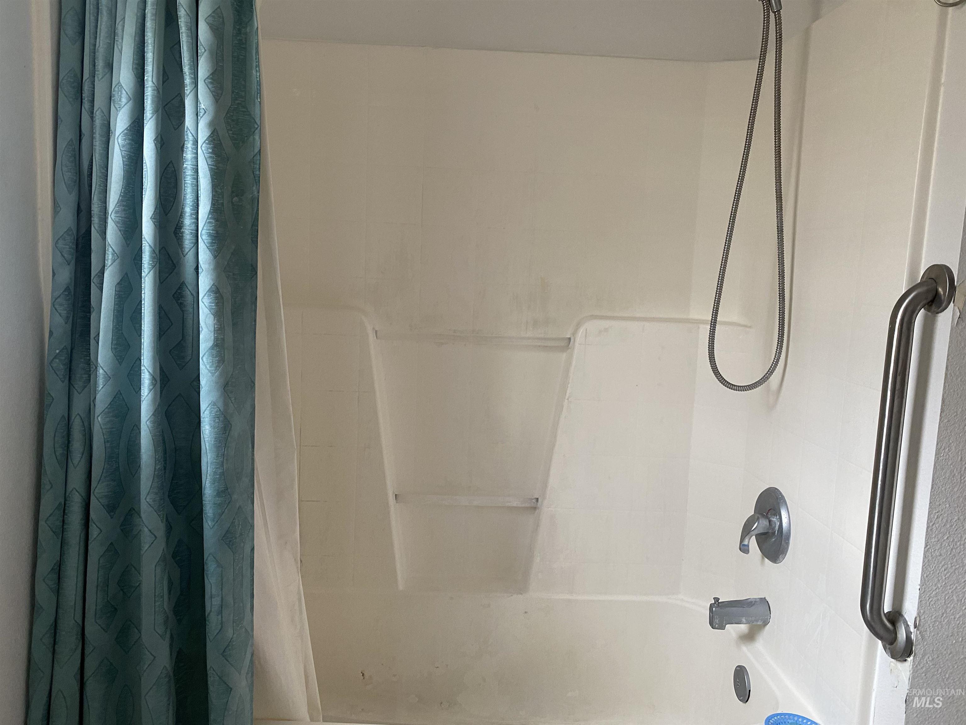 Full bathroom with shower / bathtub combination with curtain