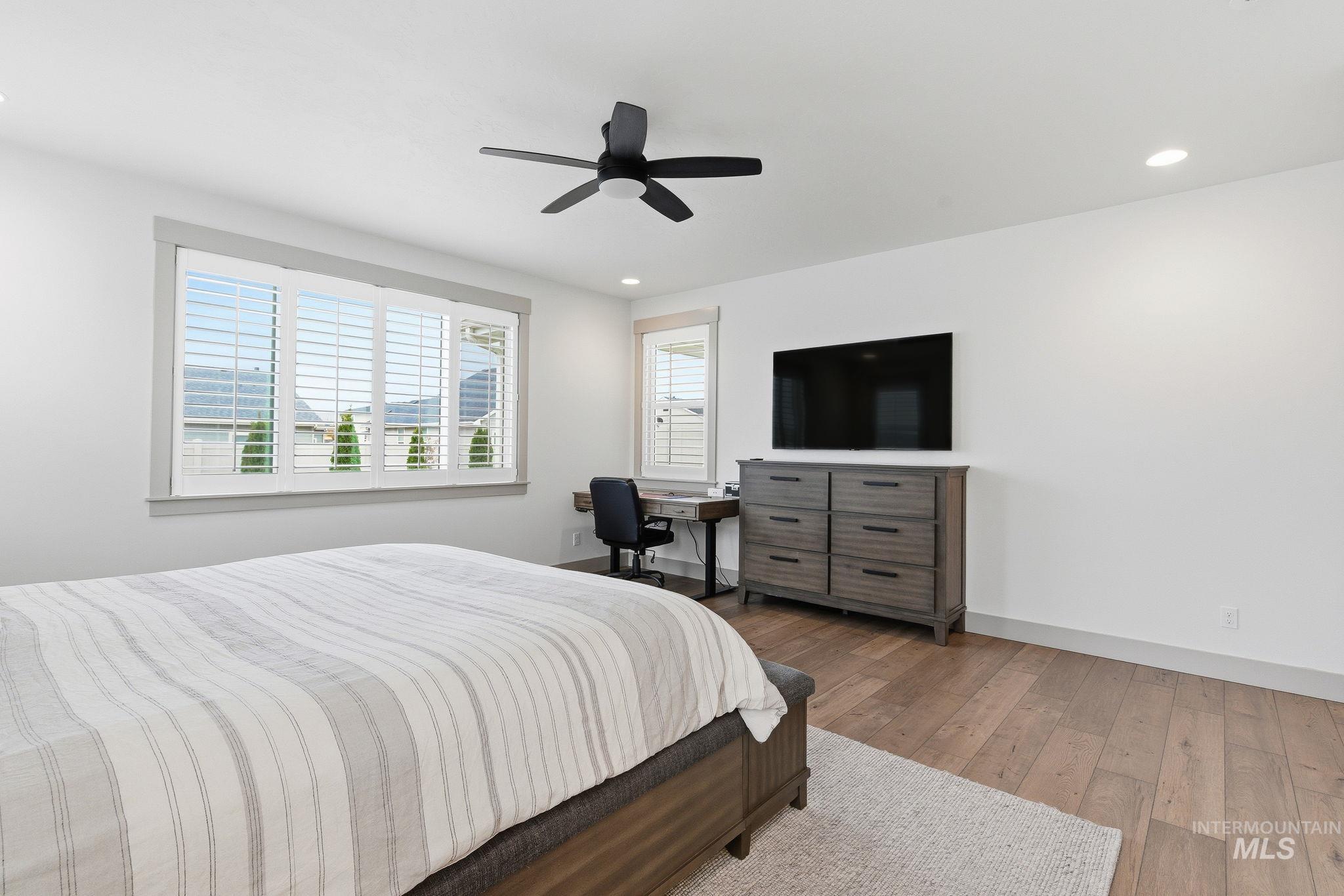 Bedroom featuring wood-type flooring, ceiling fan, and recessed lighting