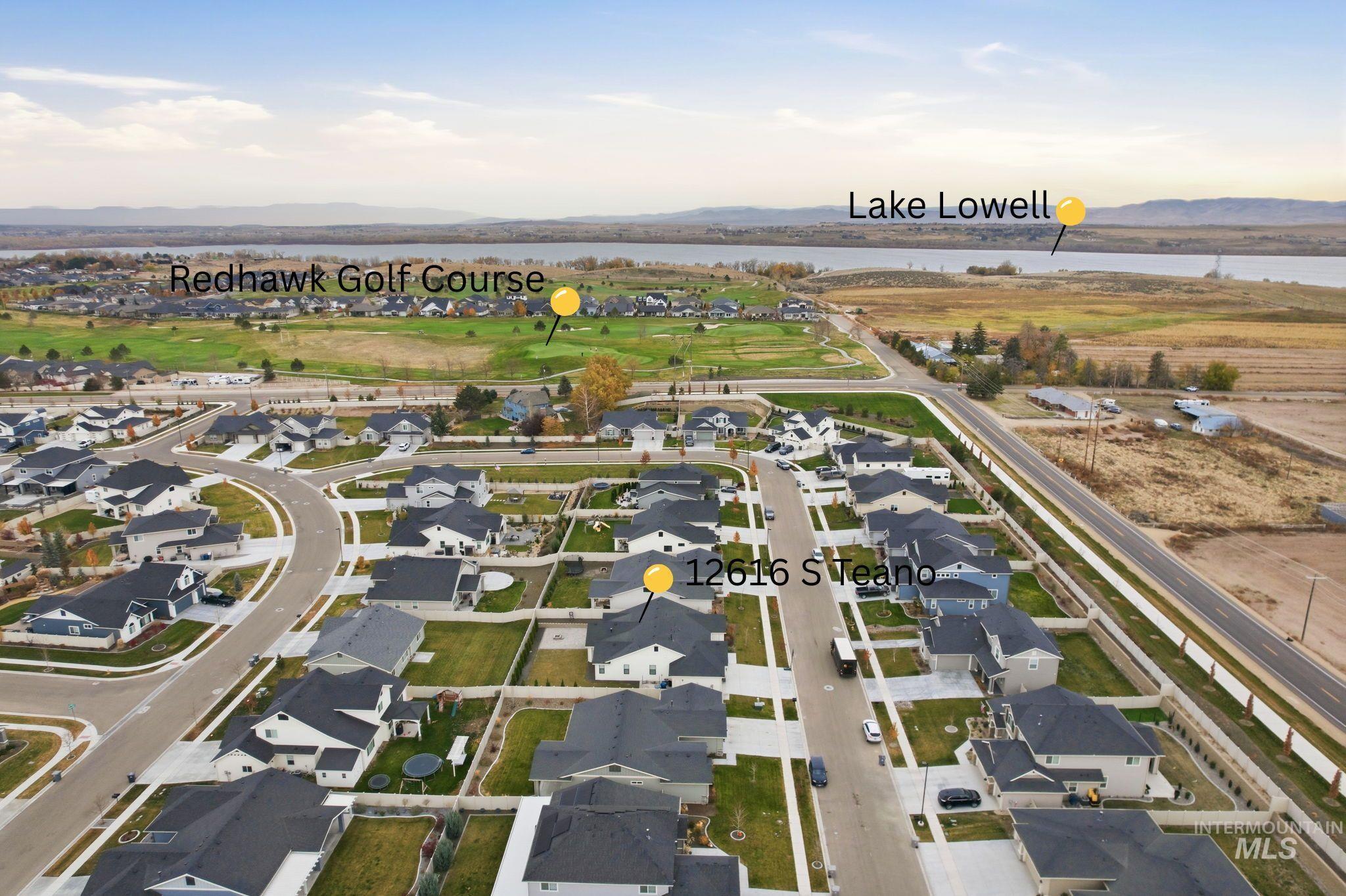 View of property location featuring nearby suburban area and a water and mountain view