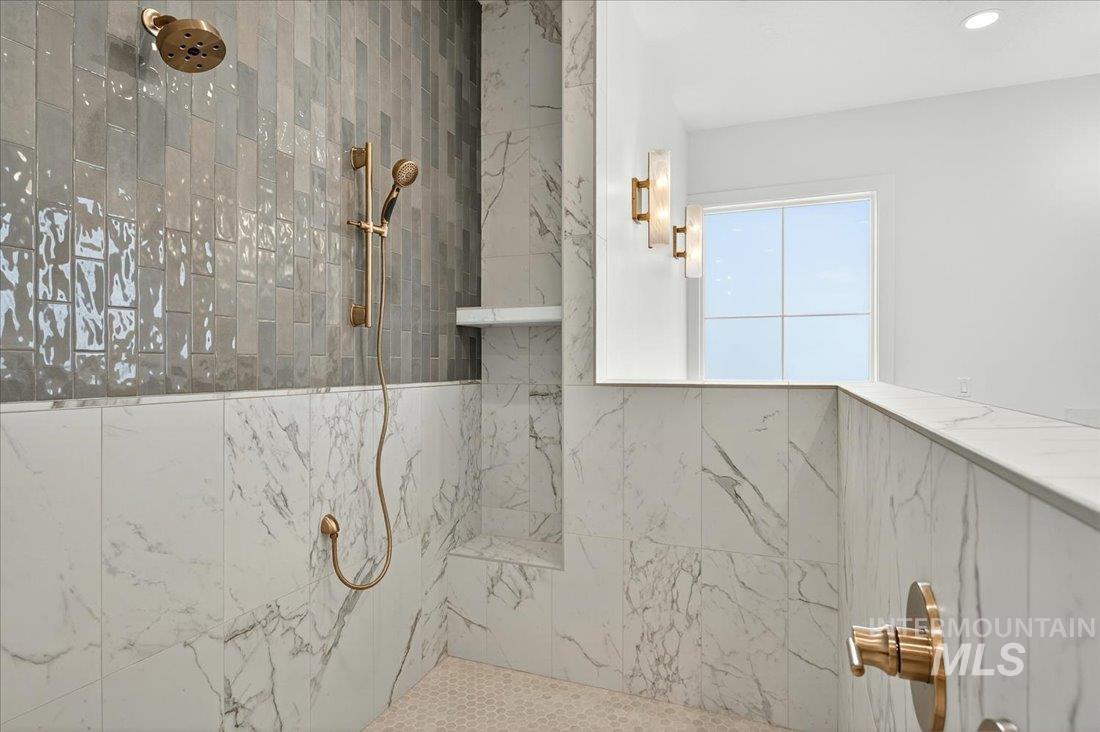Bathroom featuring a marble finish shower