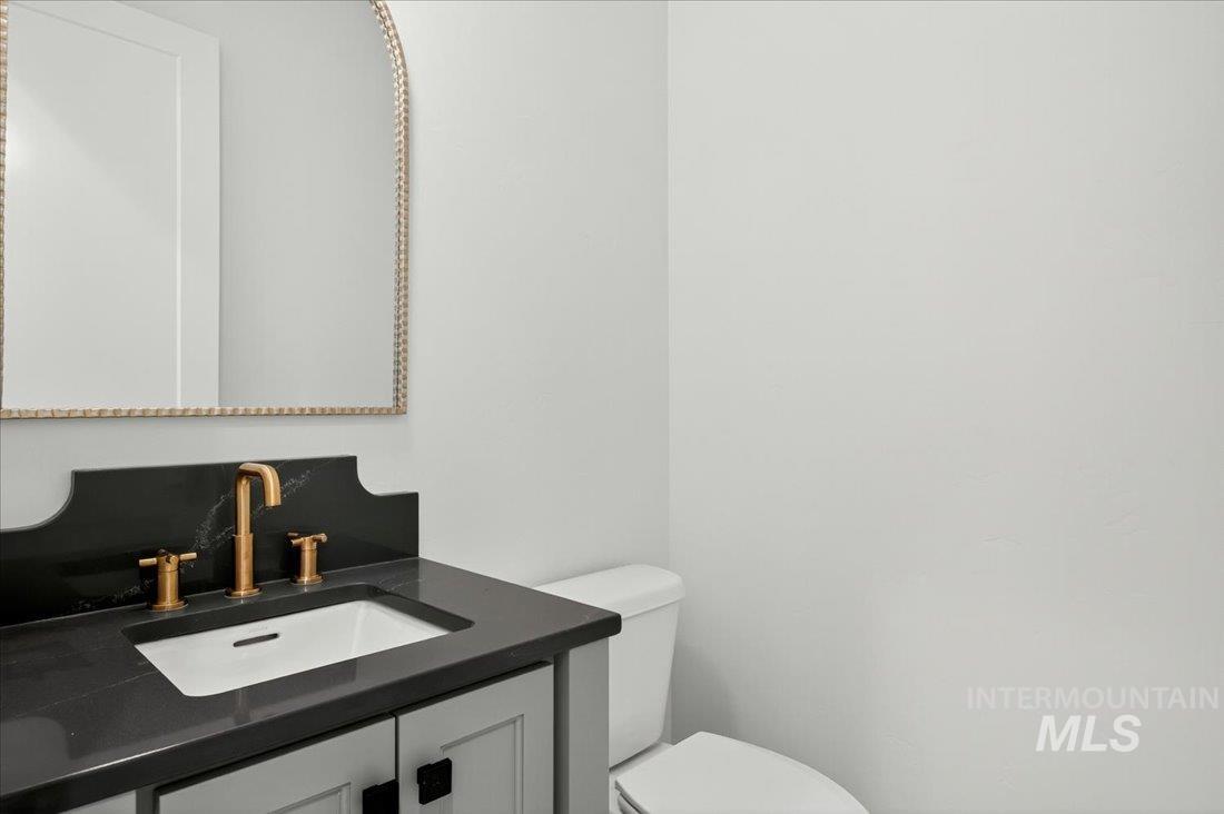 Half bath featuring vanity and toilet