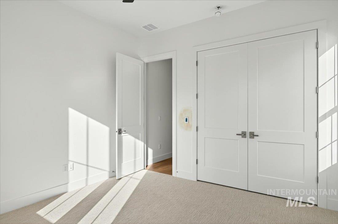 Unfurnished bedroom with carpet floors and a closet