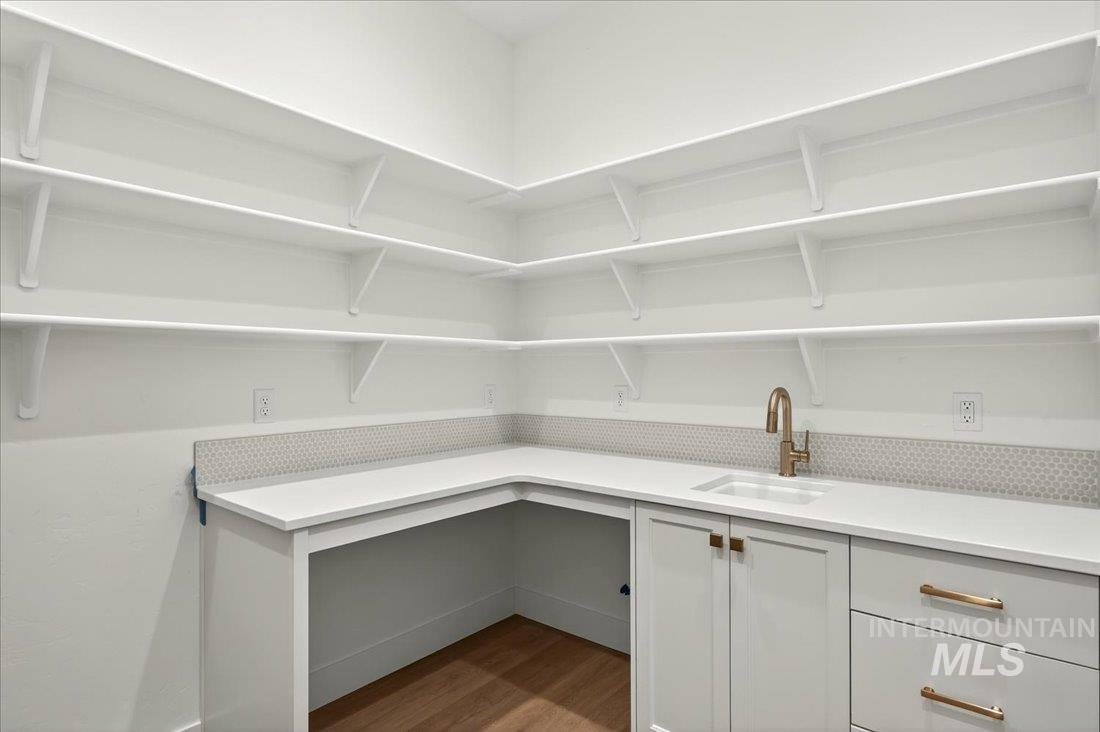 Pantry featuring a sink