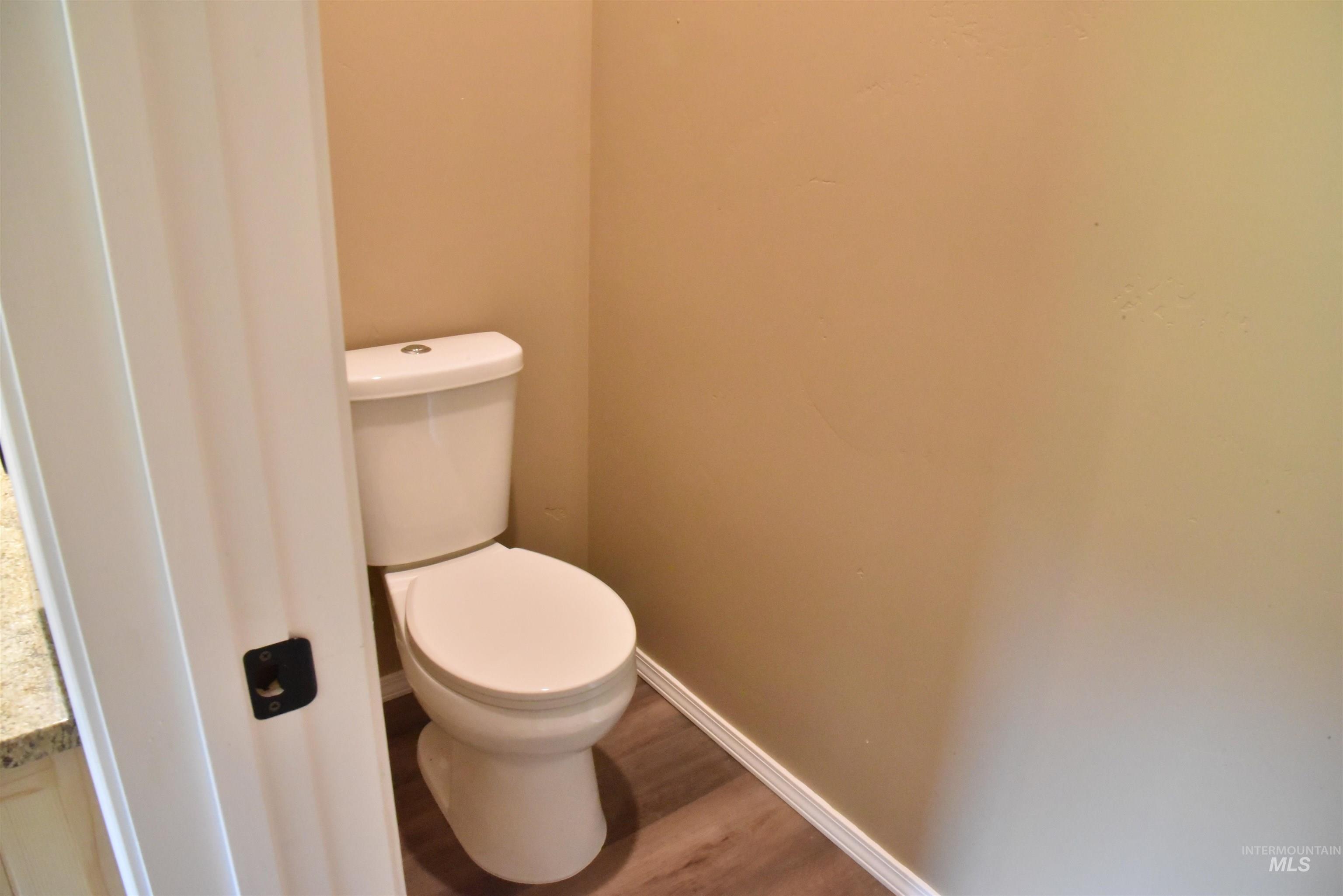 Bathroom featuring baseboards and wood finished floors