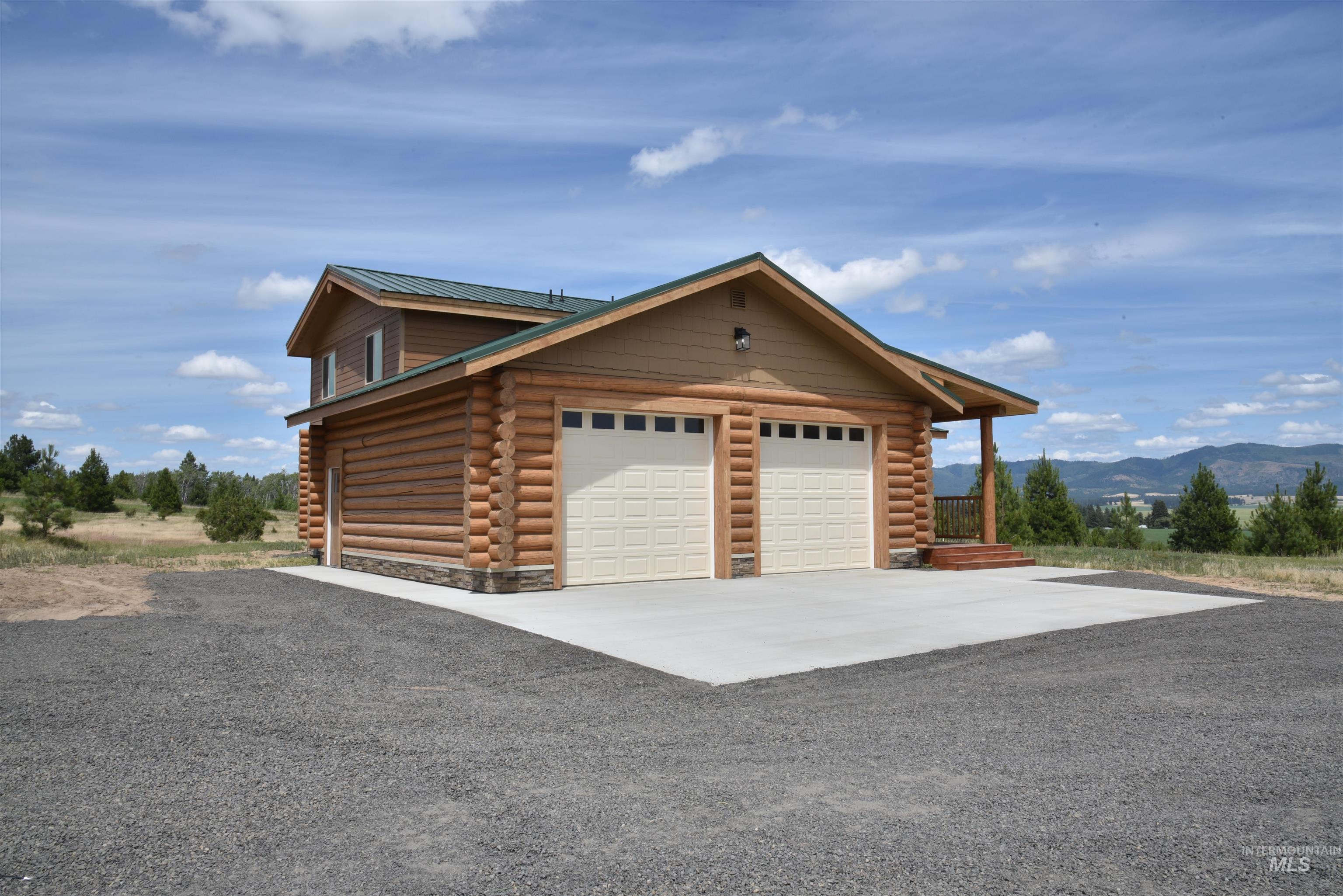 Garage with driveway and a mountain view
