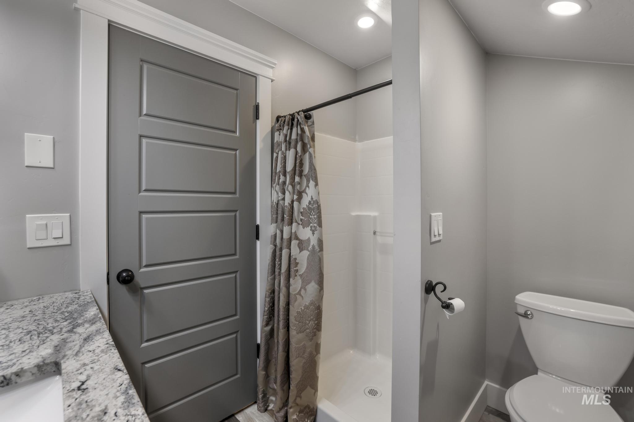 Full bathroom with a stall shower and vanity
