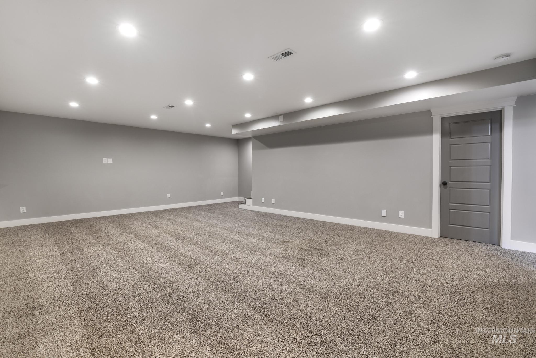 Finished basement featuring light carpet and recessed lighting