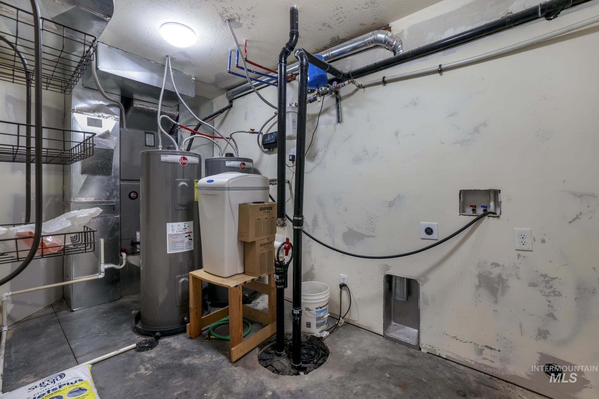 Utilities featuring electric water heater, heating unit, and drainage system