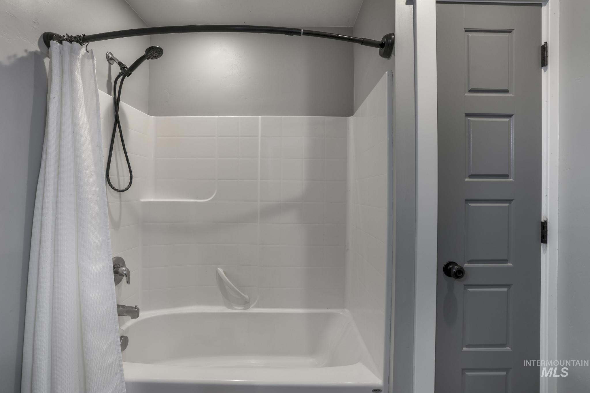Full bathroom with shower / bath combination with curtain