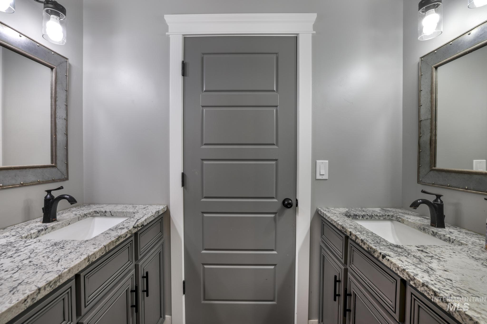 Full bath featuring two vanities