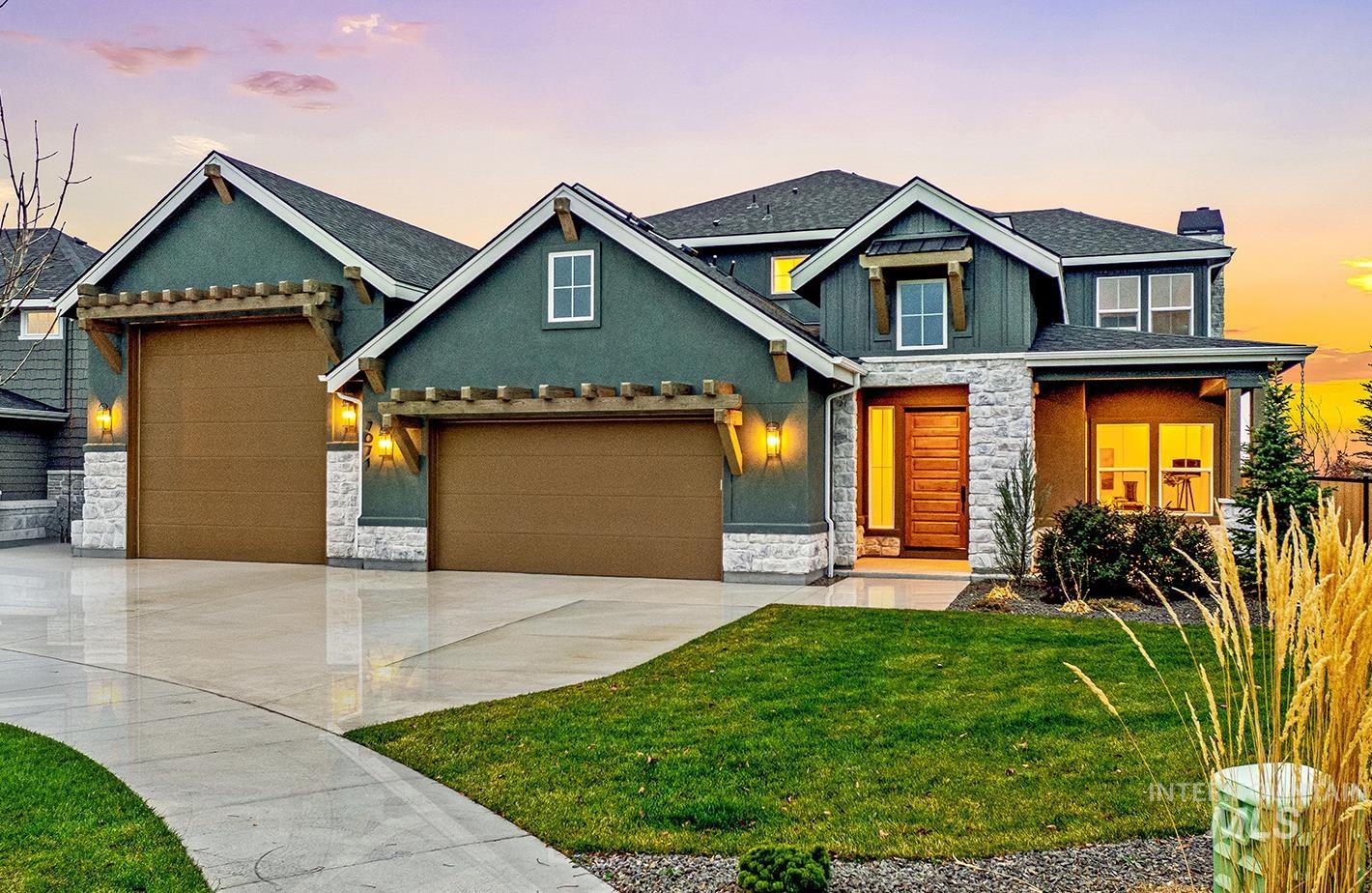 Craftsman house featuring stone siding, a chimney, a front lawn, concrete driveway, and a garage