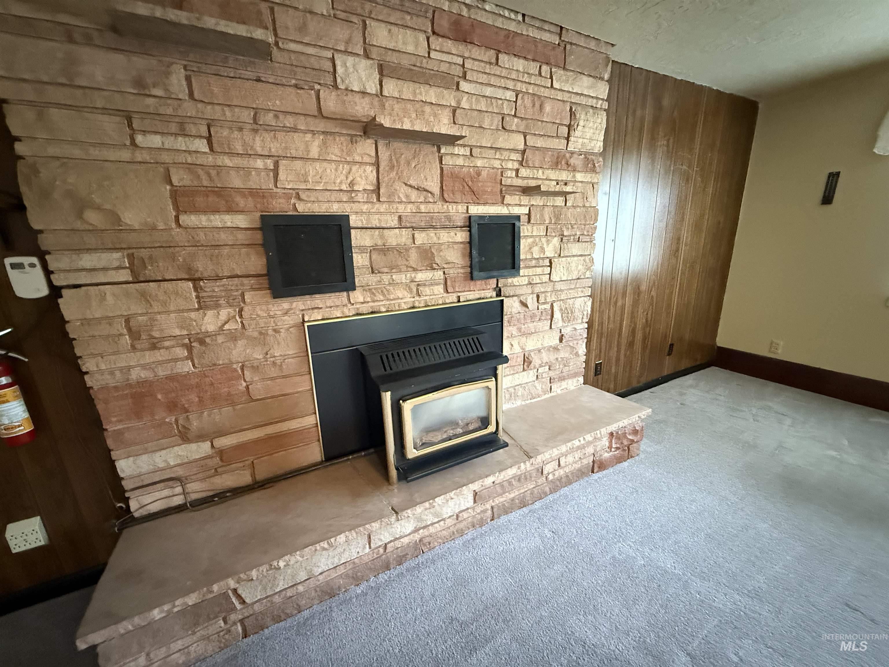 Detailed view of wood walls and carpet floors