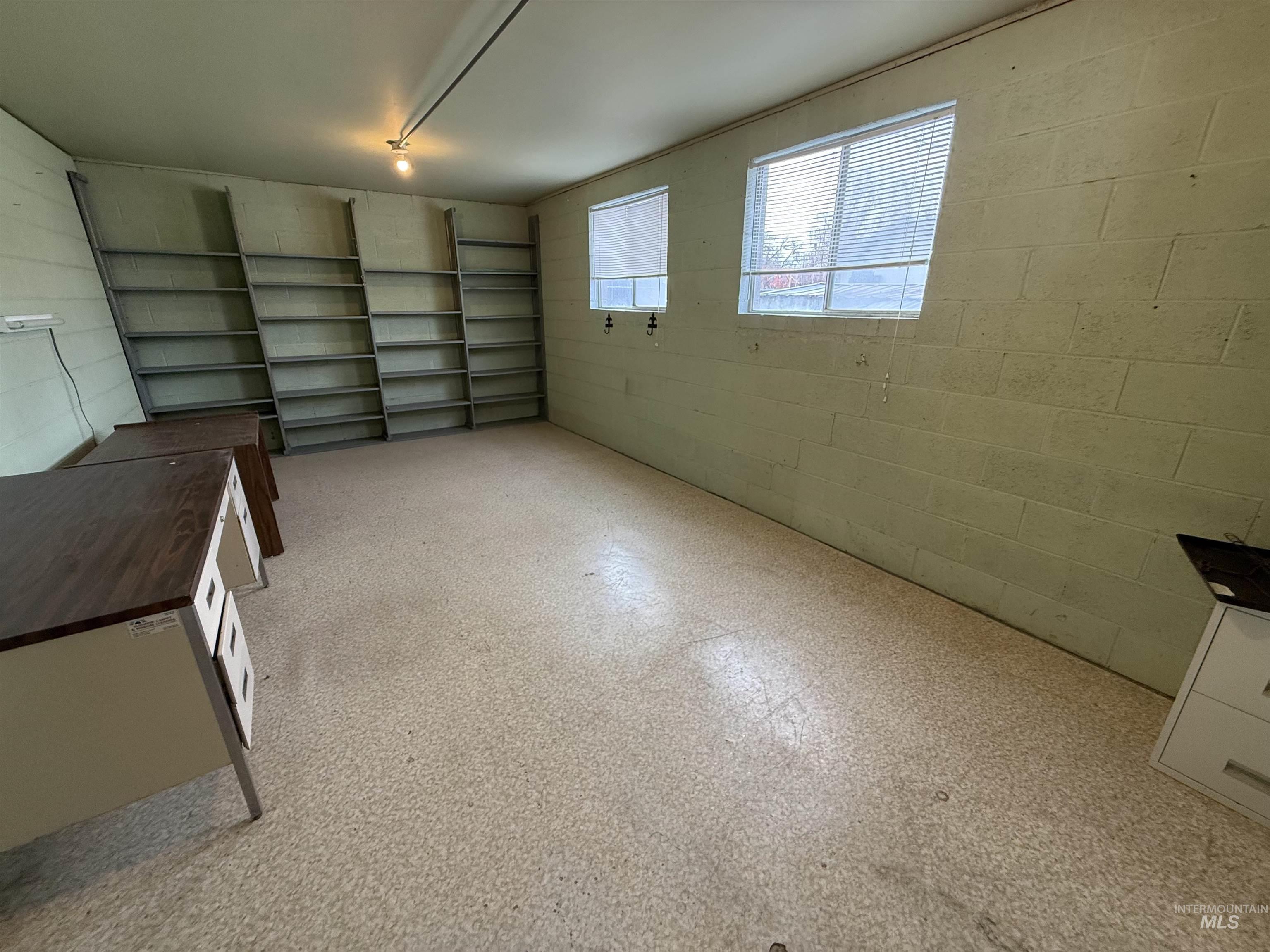 Garage featuring concrete block wall