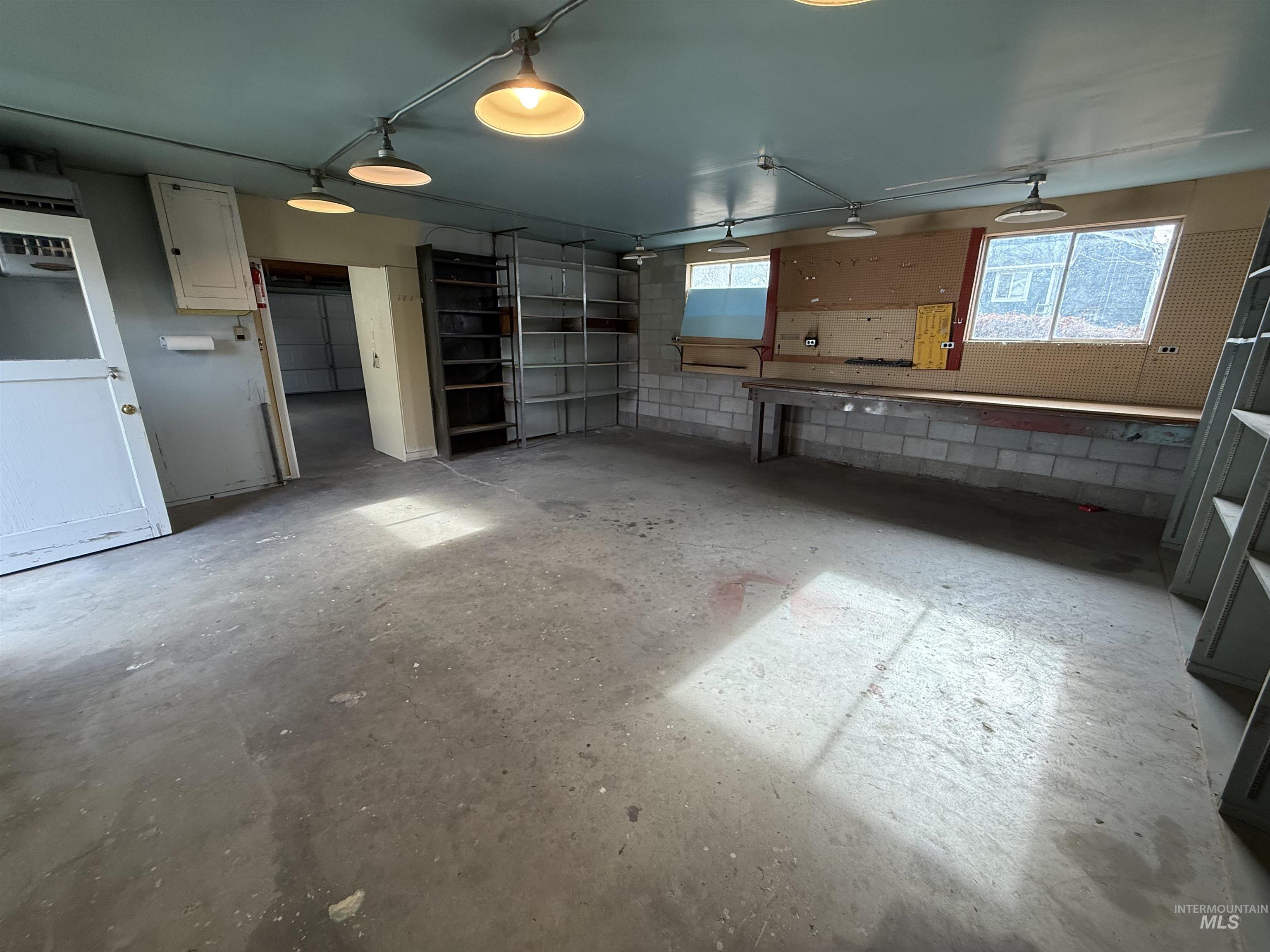 Kitchen featuring concrete flooring and concrete block wall