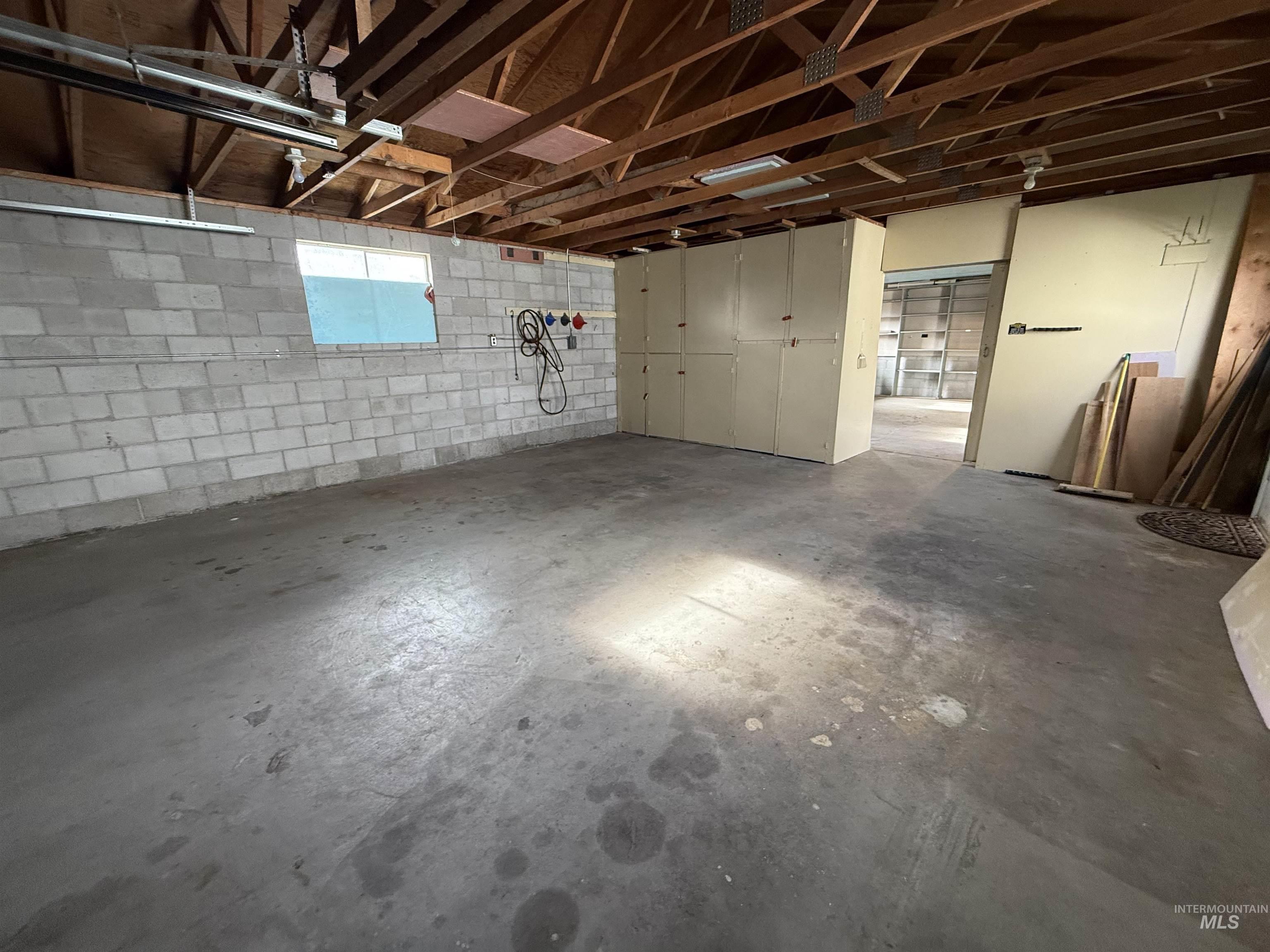Garage featuring concrete block wall