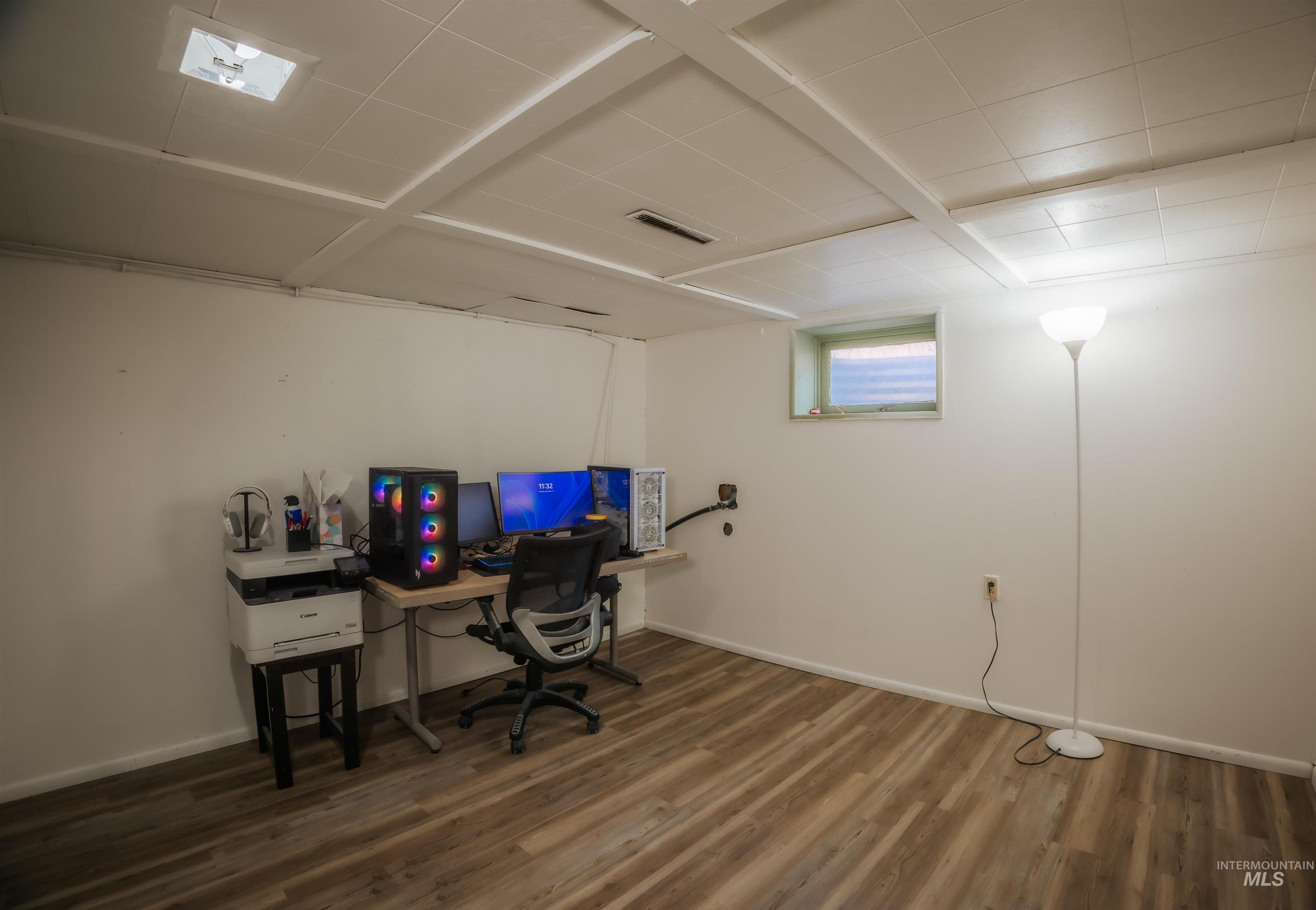 Office space with wood finished floors and baseboards