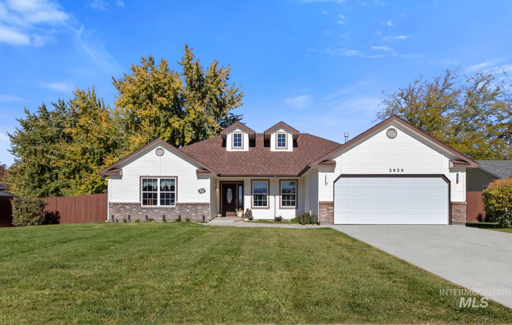 View of front of home featuring brick siding, concrete driveway, a garage, and roof with shingles