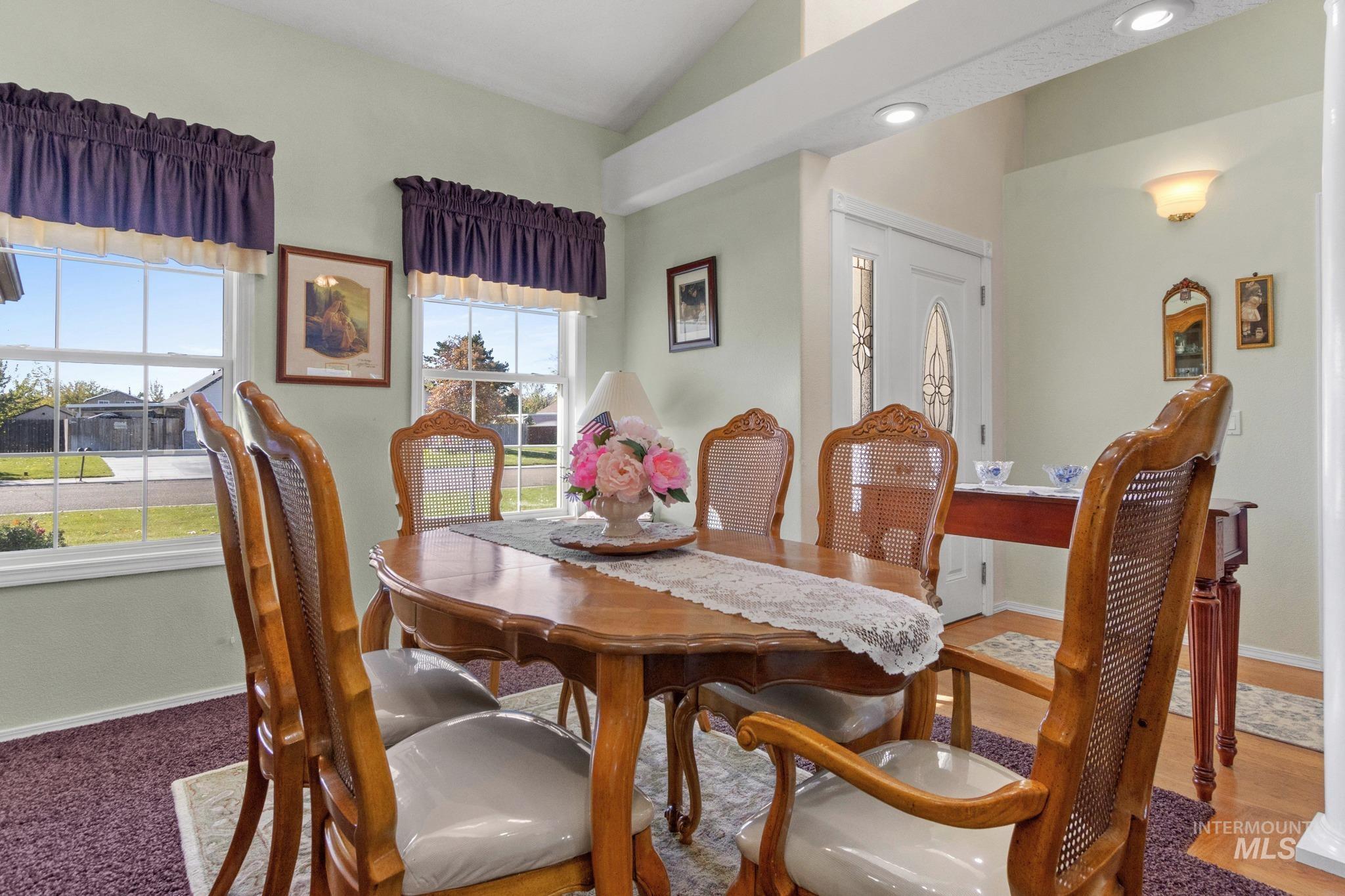 Dining area featuring lofted ceiling and recessed lighting