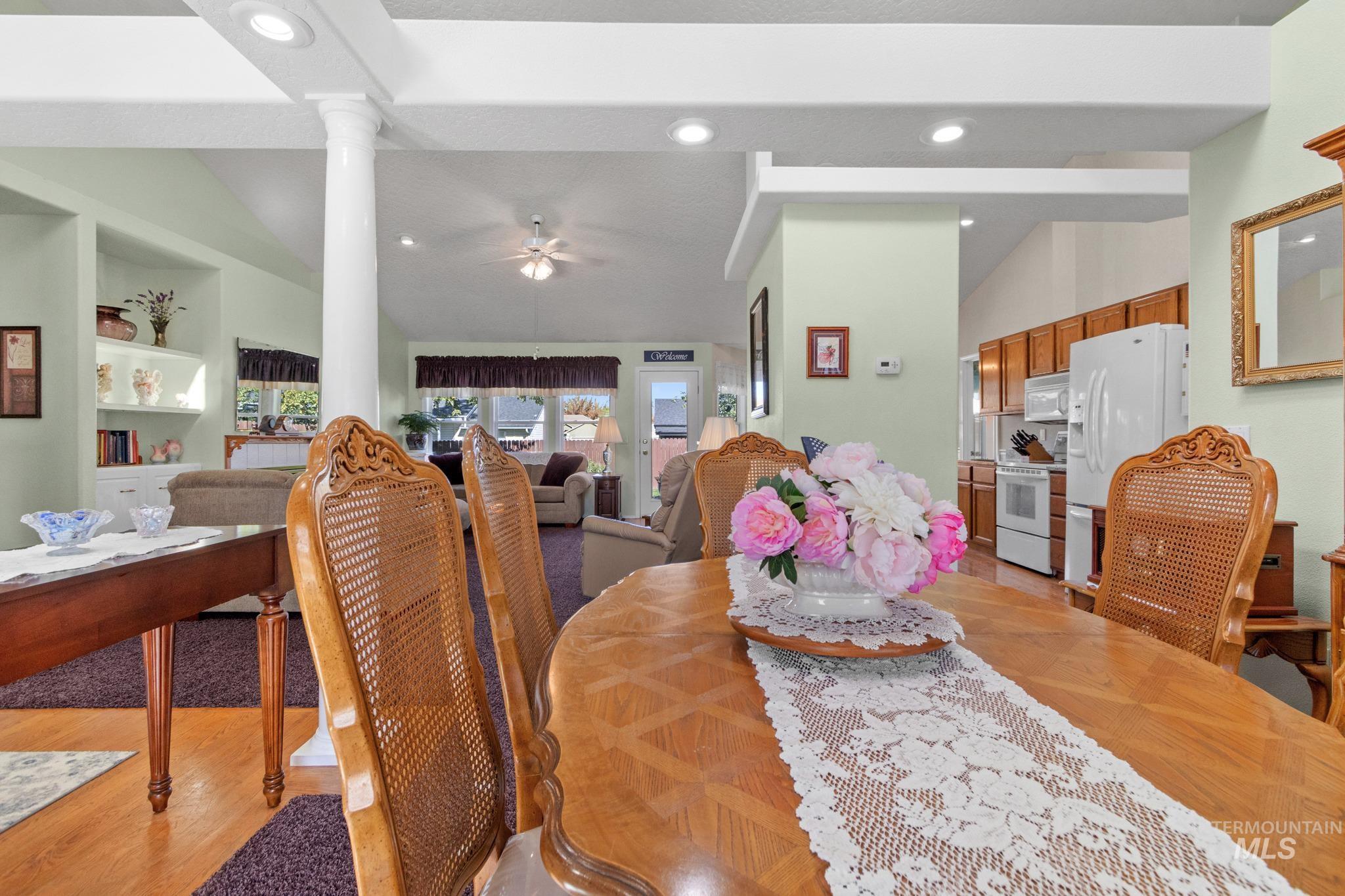 Dining space with lofted ceiling, a ceiling fan, recessed lighting, and light wood-style floors