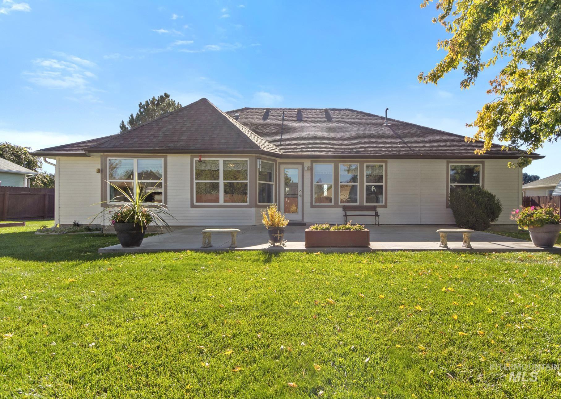 Back of property featuring a patio area and roof with shingles