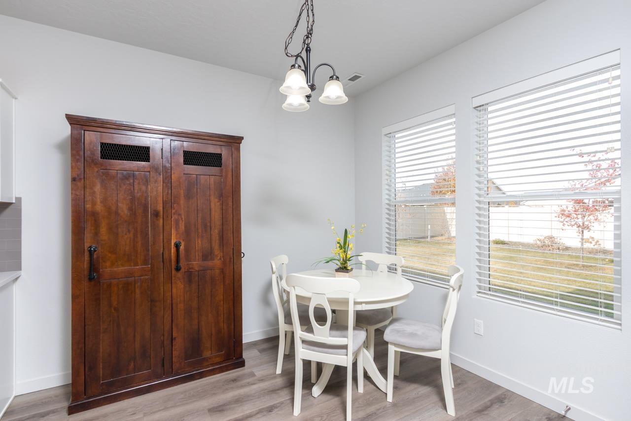 Dining area with light wood-type flooring and a chandelier