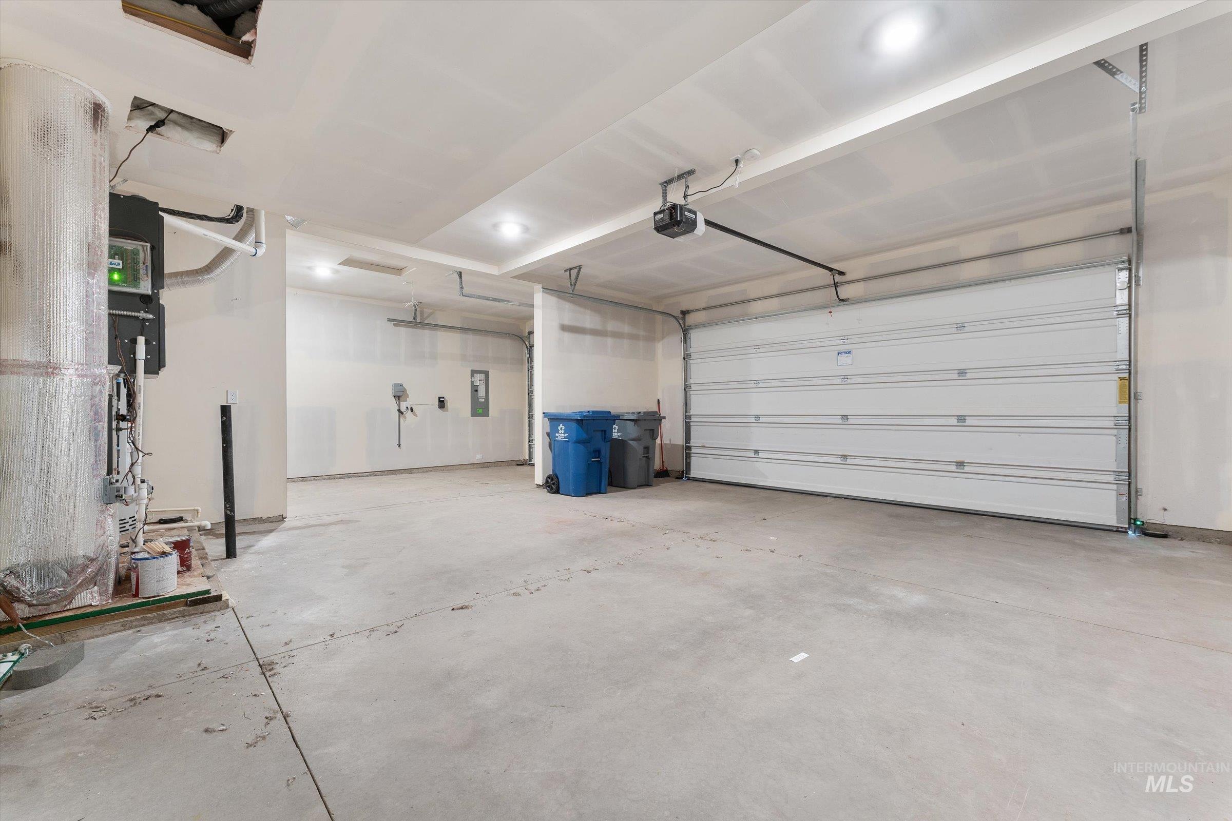 Garage with electric panel and a garage door opener