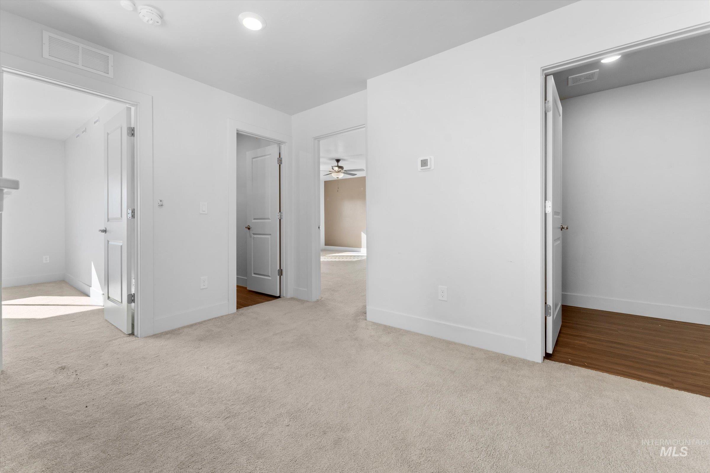 Unfurnished bedroom with light colored carpet and recessed lighting