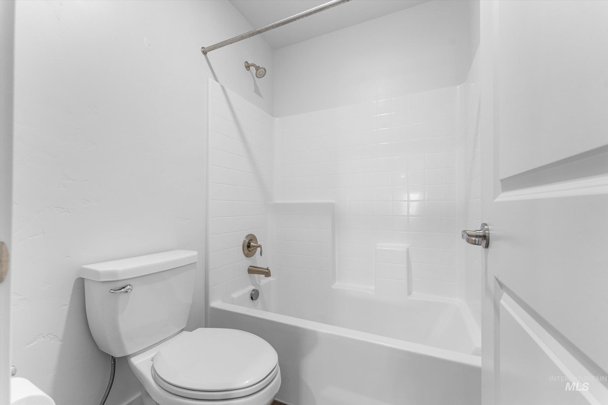 Full bath with bathing tub / shower combination and toilet