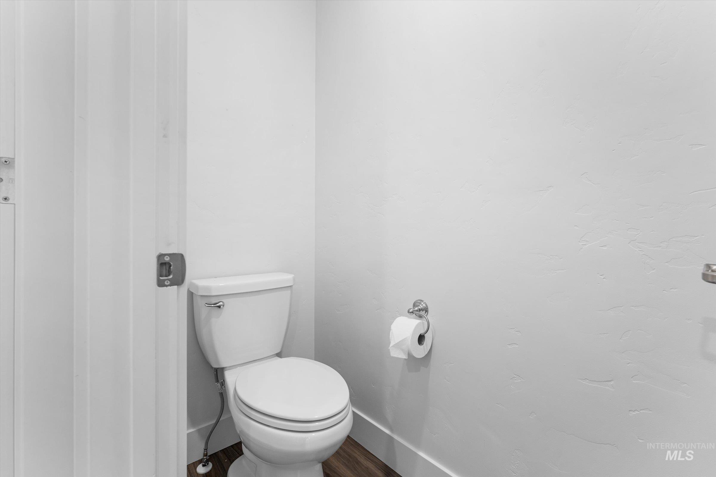 Bathroom featuring baseboards and wood finished floors