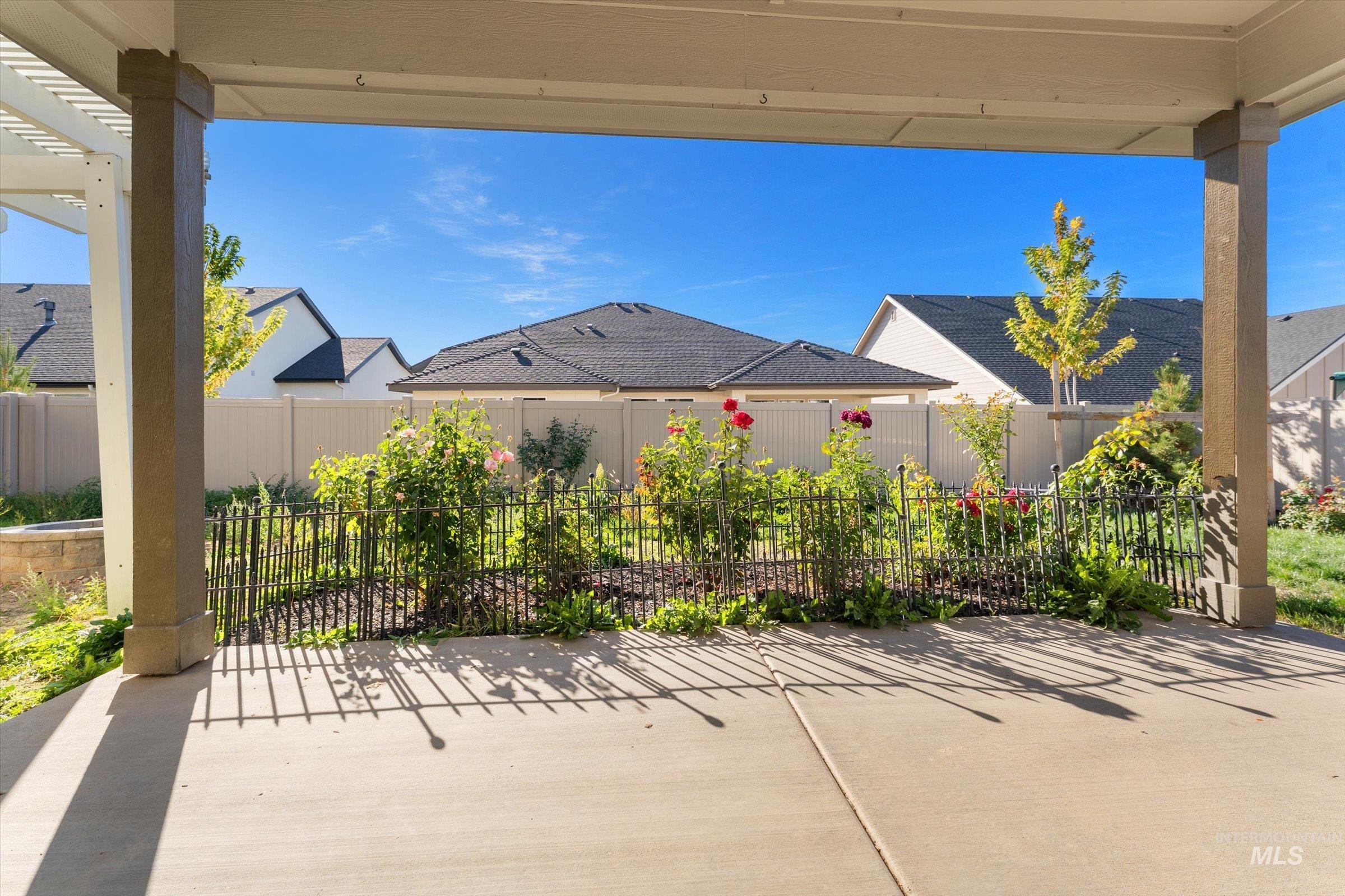 Fenced backyard featuring a patio area and a residential view