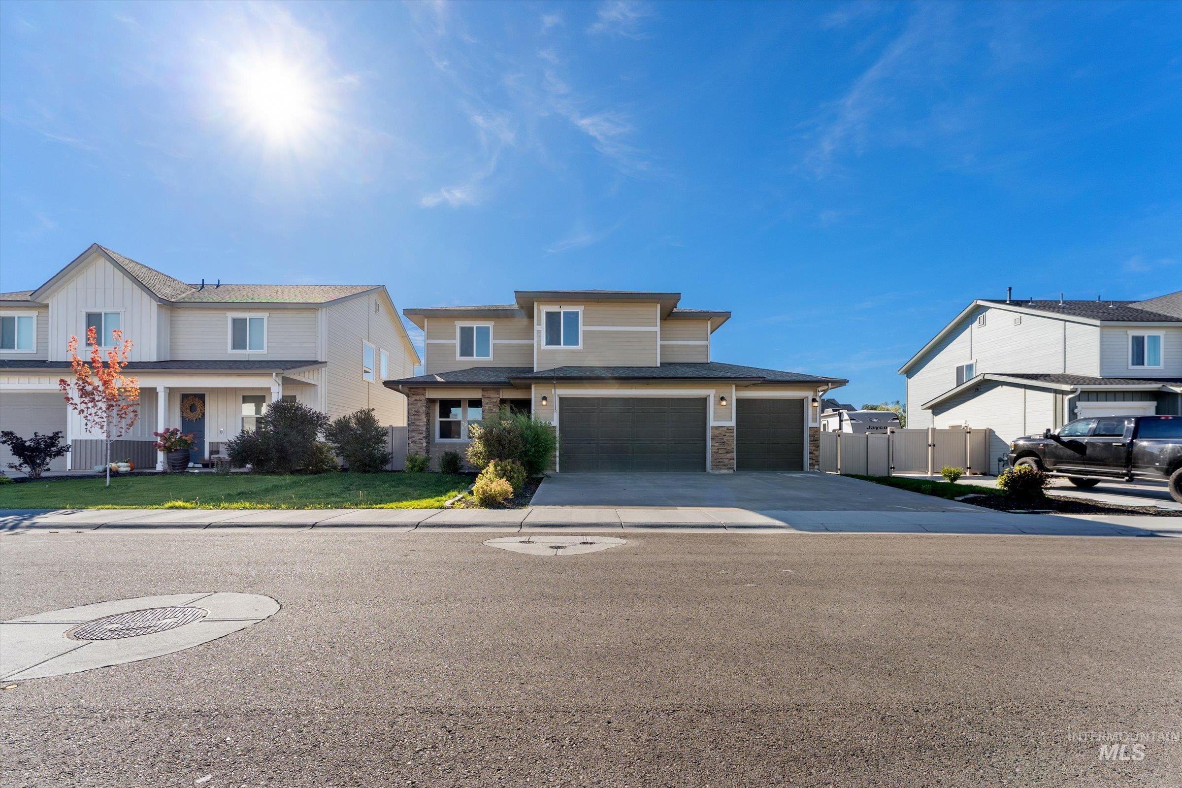 View of front of property with driveway, stone siding, and a porch